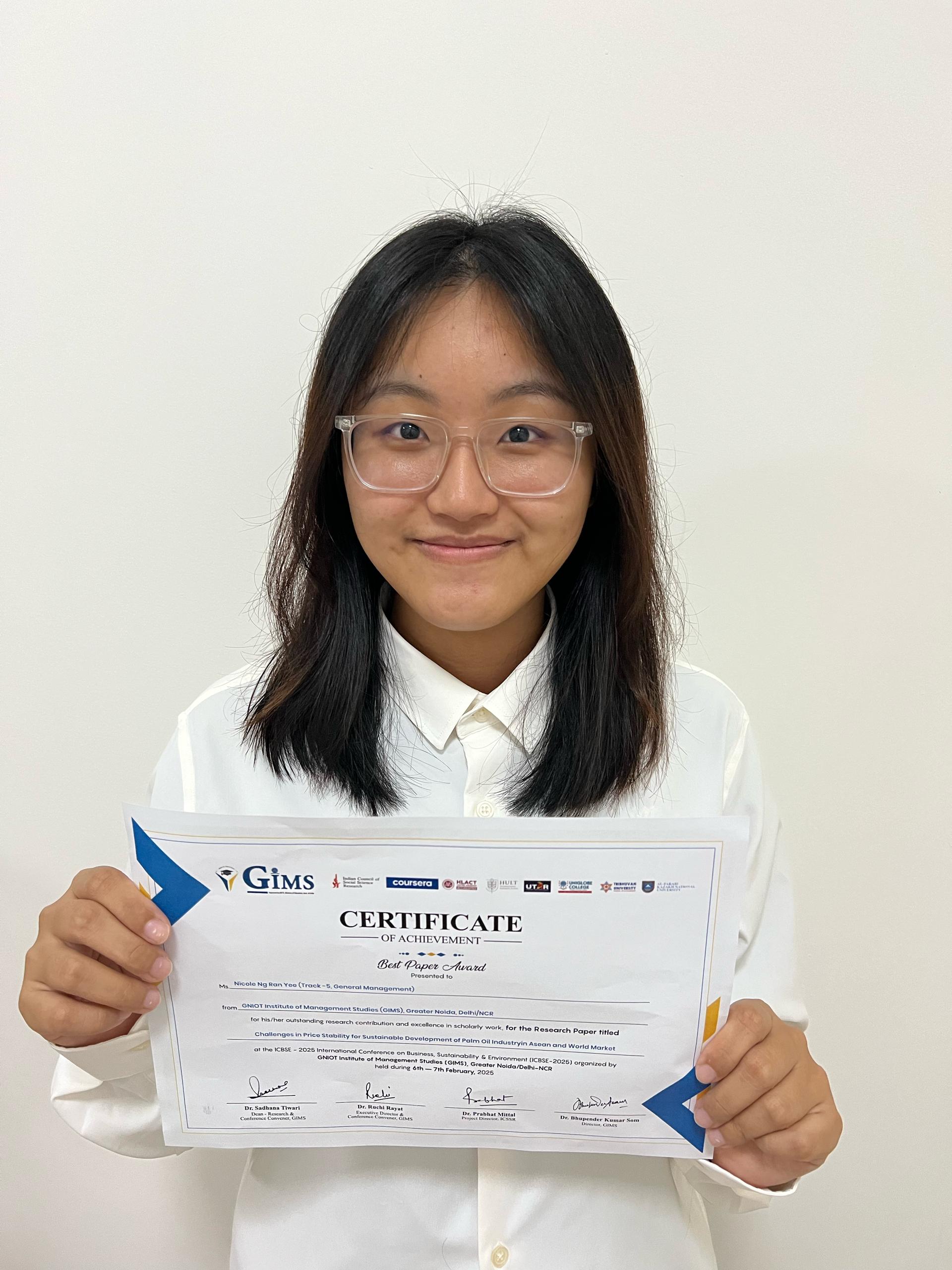 Nicole Ng and her certificate of achievement
