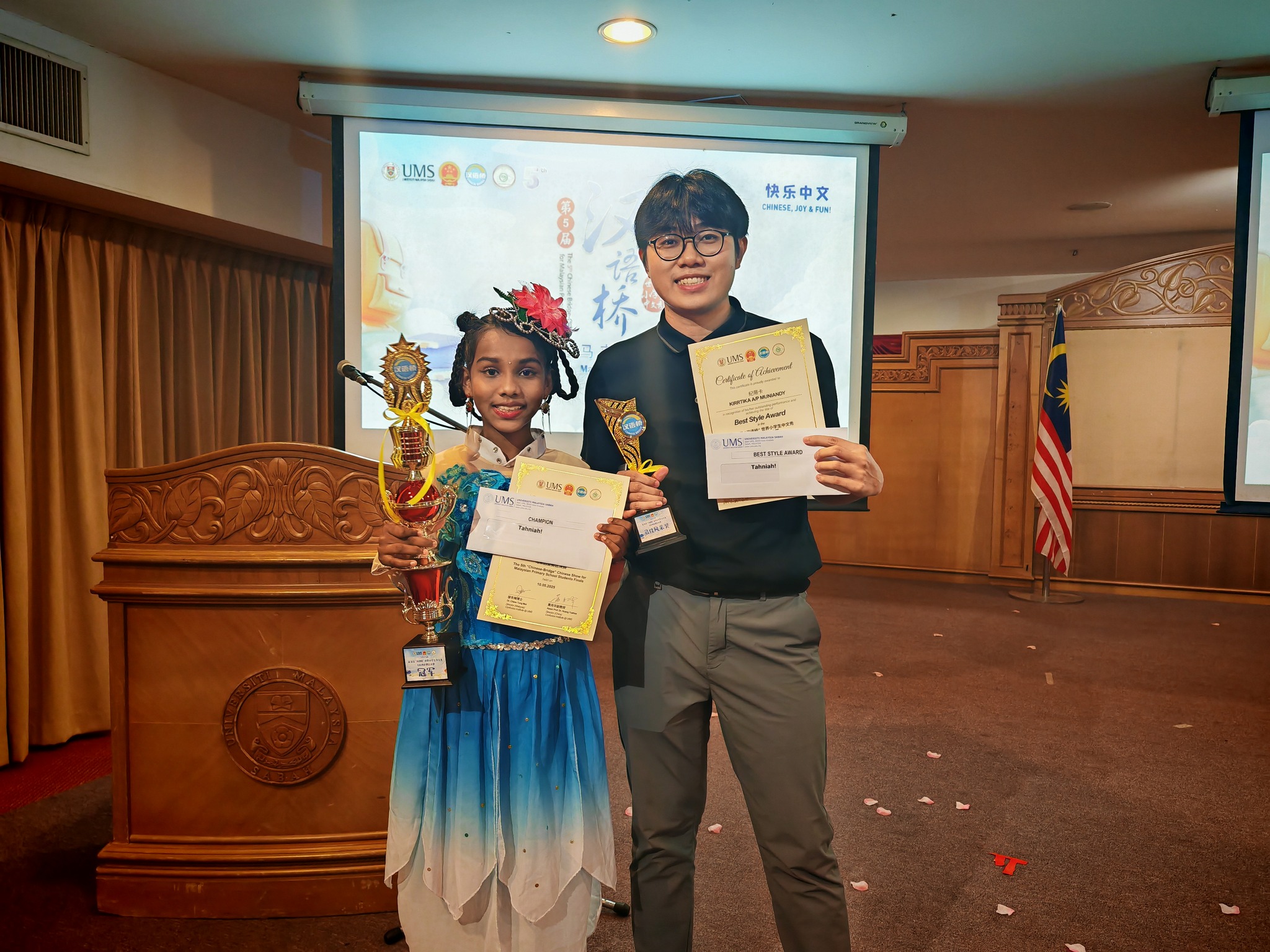 Kirrtika (left) and Mr Tan celebrating their moment of honour