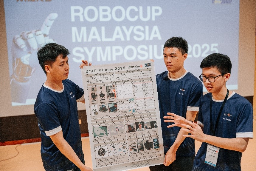 Lim Zi Quan, Er Kai Sheng and Ooi Soo Jack presenting their poster
