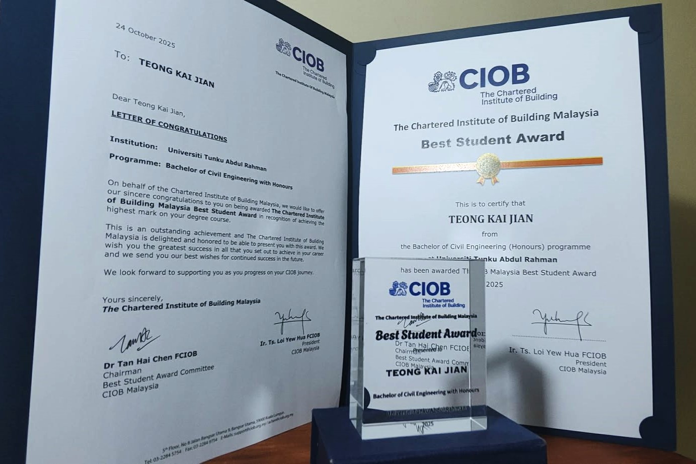 Certificate, trophy, and the letter of congratulations presented to Teong