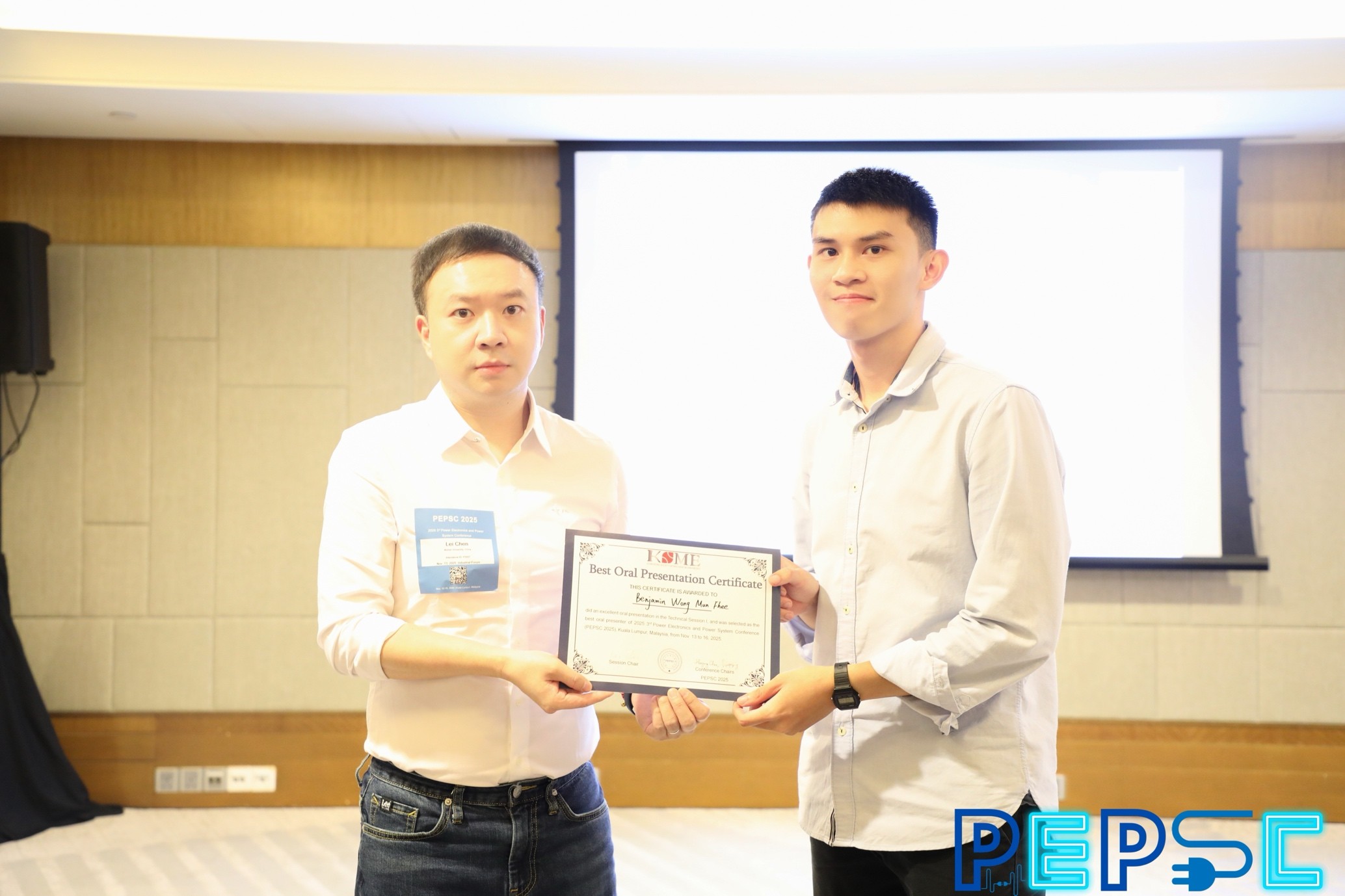 Benjamin Wong (left) receiving his certificate from organiser