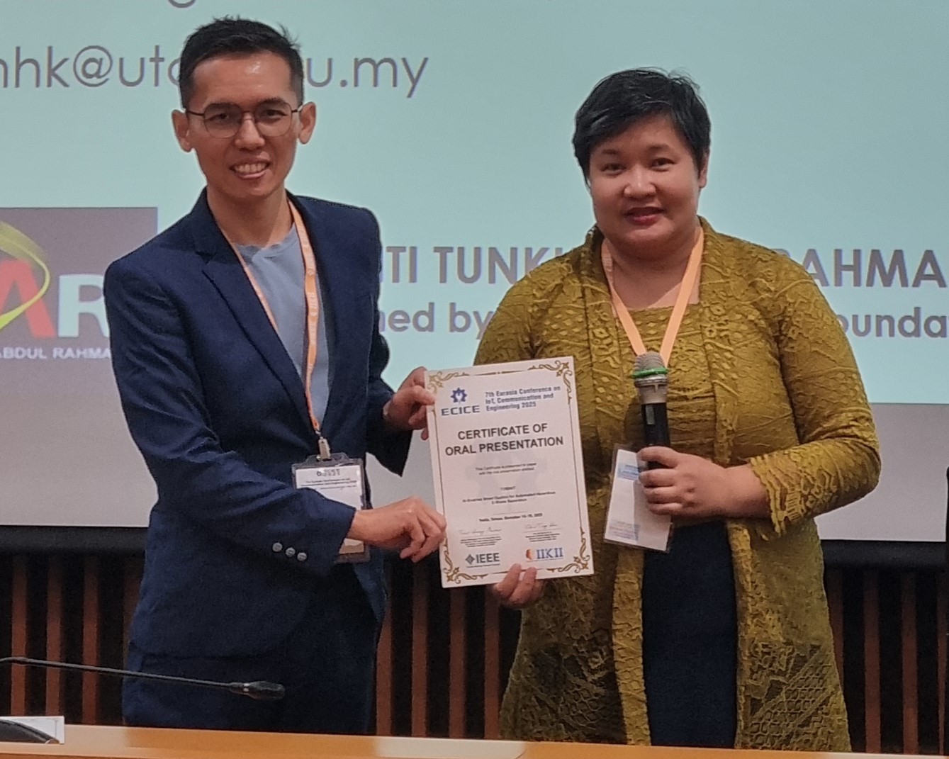 Dr Mun (left) receiving his certificate