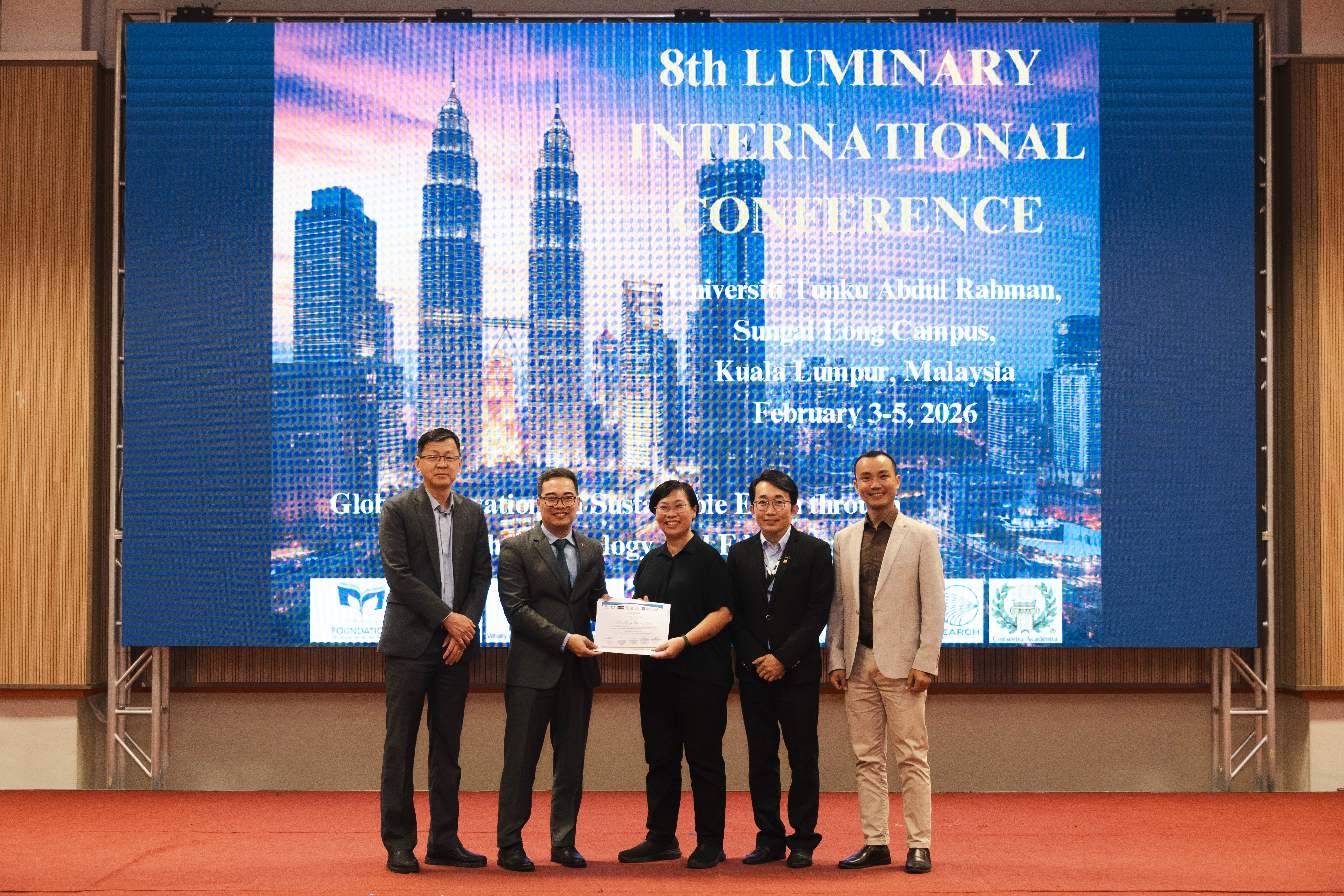 Ms Lim (third from left) receiving her certificate