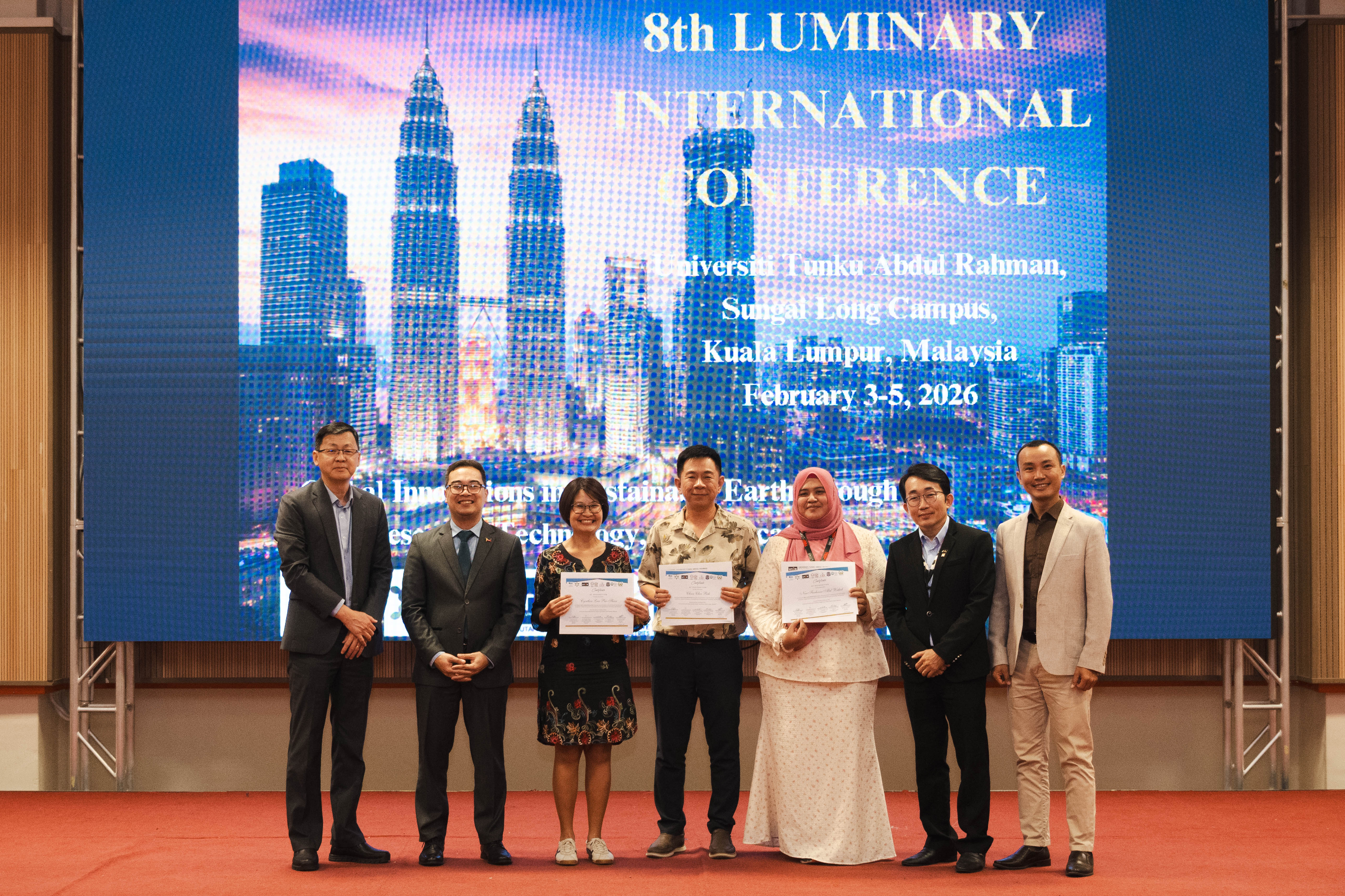 Third from left: Dr Cynthia Lau, Mr Beh and Cik Nur Farhana receiving their certificate