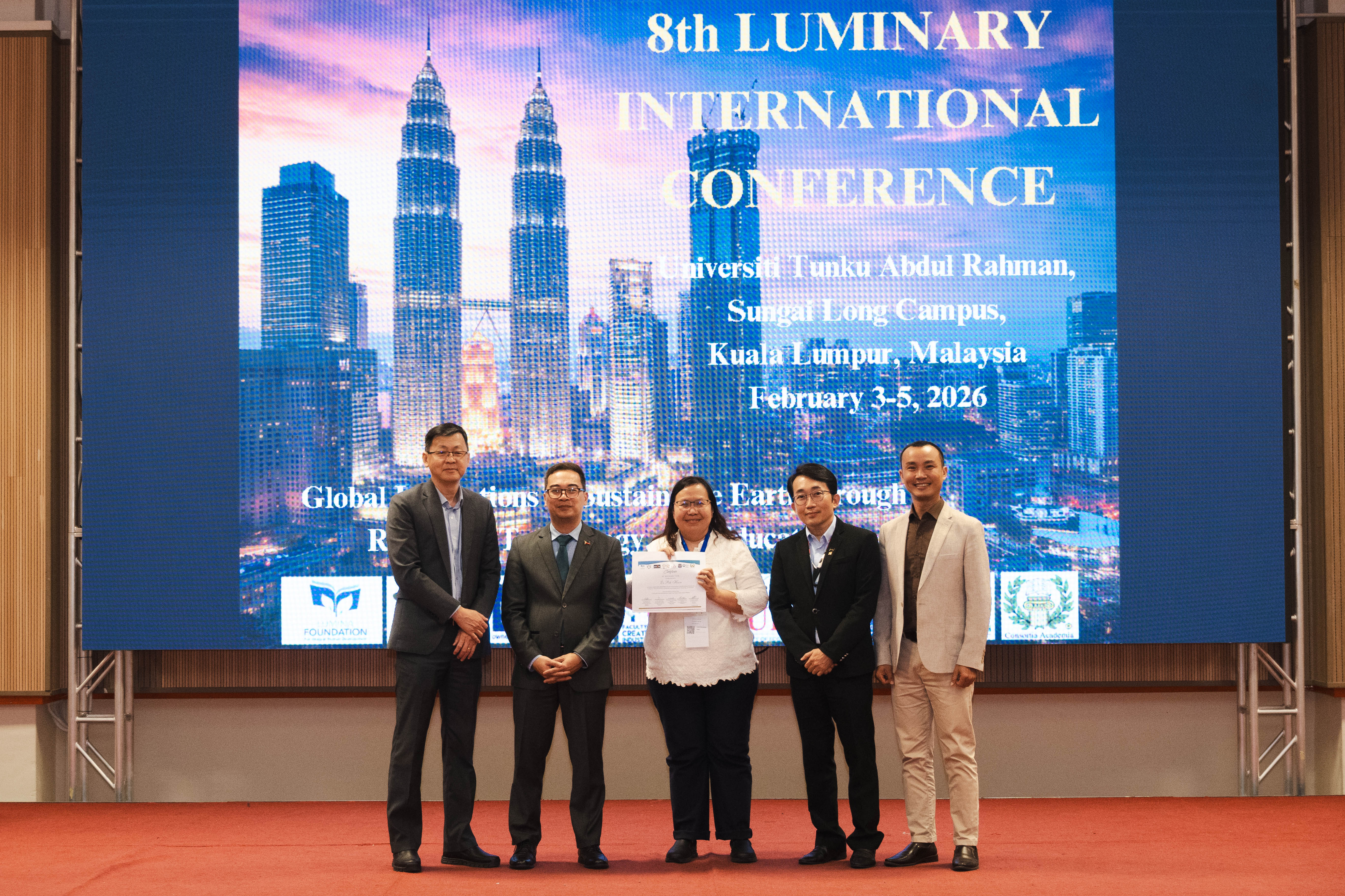 Ms Er (third from left) receiving her certificate