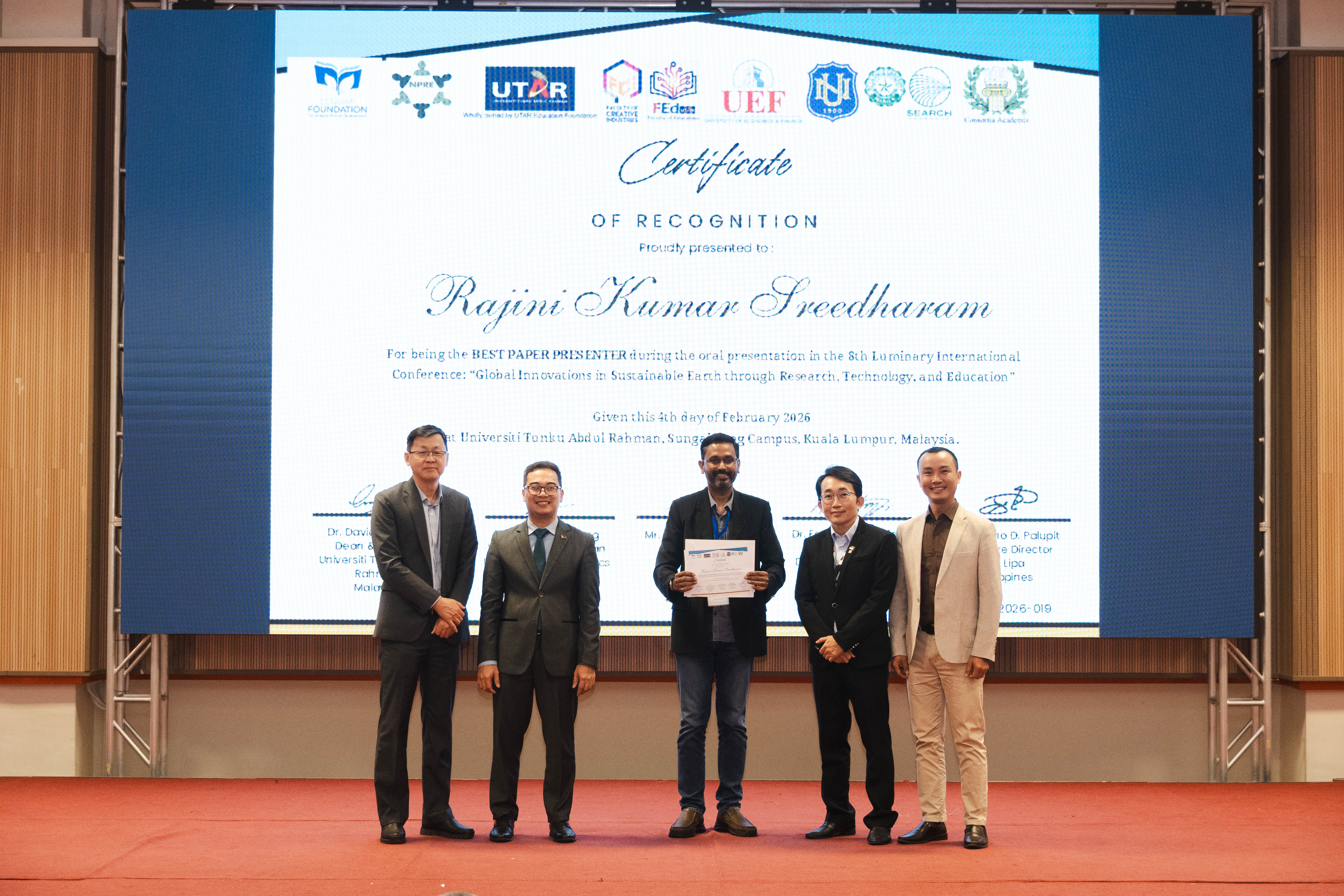 Dr Rajini (third from left) receiving his certificate