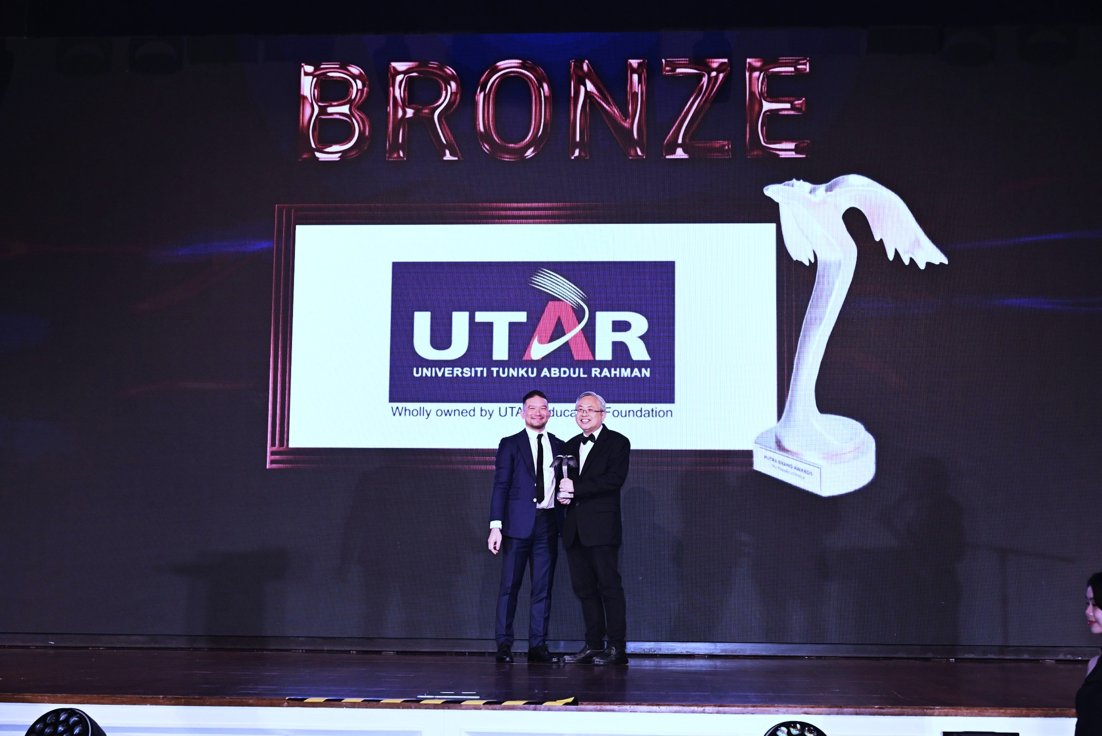 Prof Dato’ Ewe (right) receiving the award on stage
