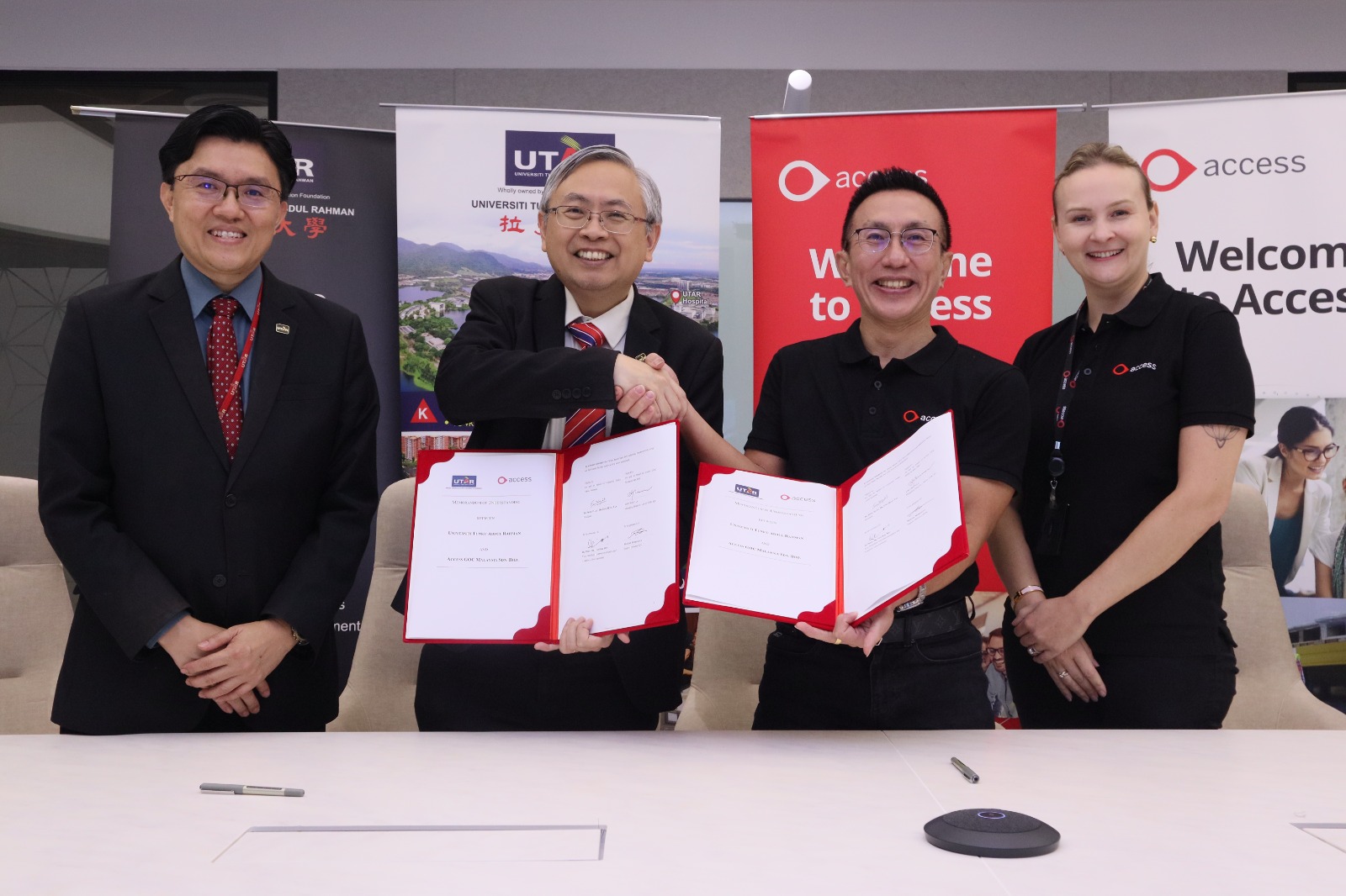 Prof Dato’ Ewe (second from left) and Mr Lim (second from right) displaying the signed documents, witnessed by Prof Goi (most left) and Ms Morozova (most right)