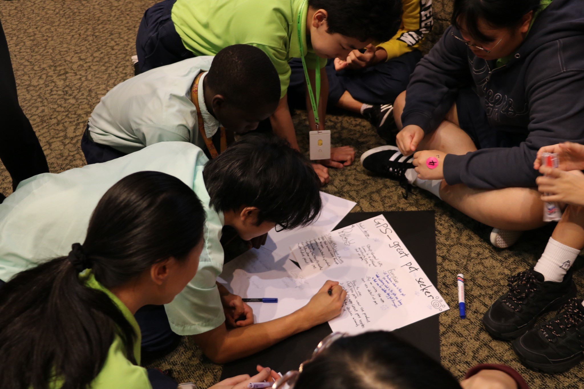 Business Pitch Challenge: A team of students engaging in a lively discussion