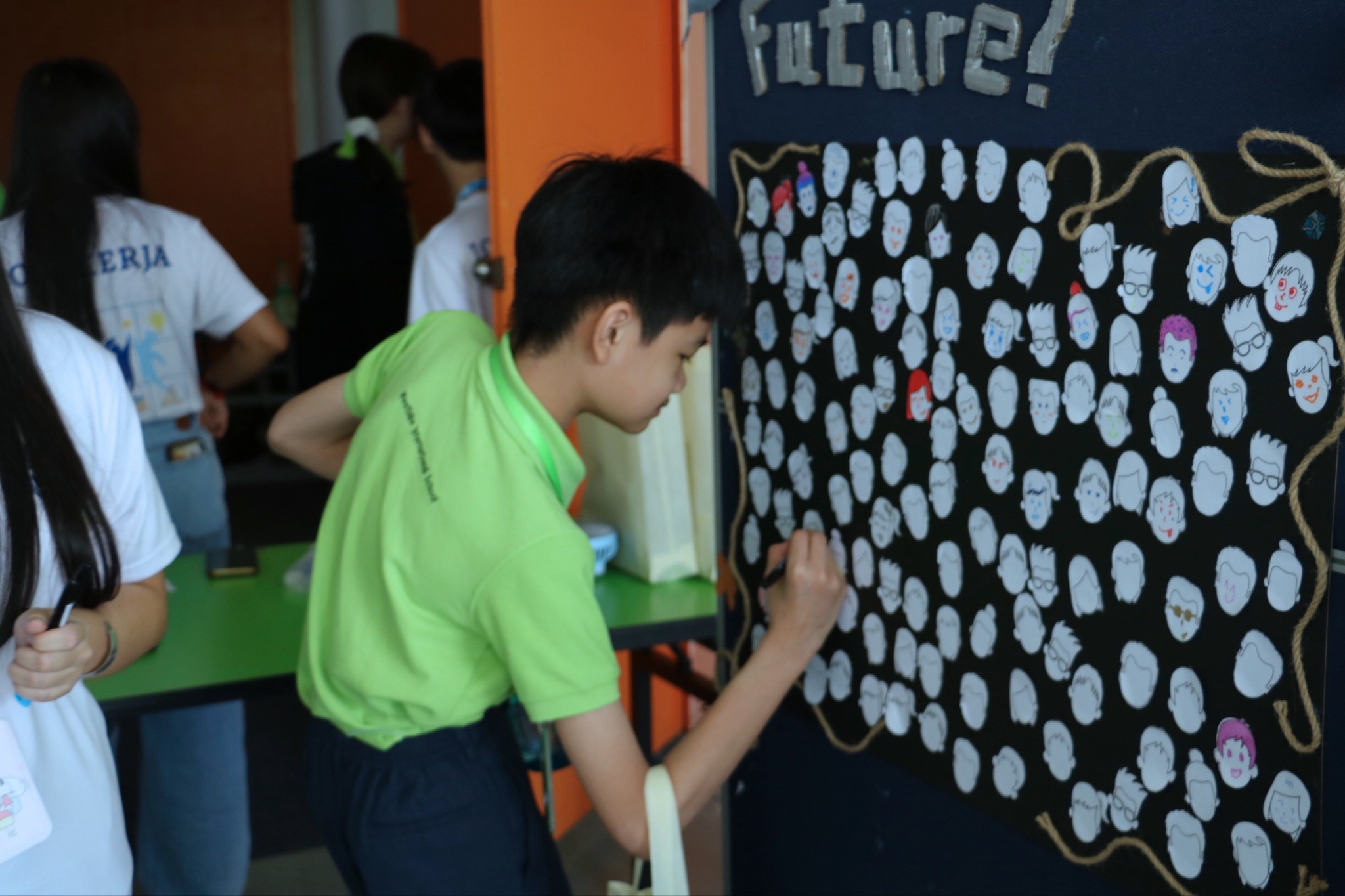 Students writing down their dream careers on the message board