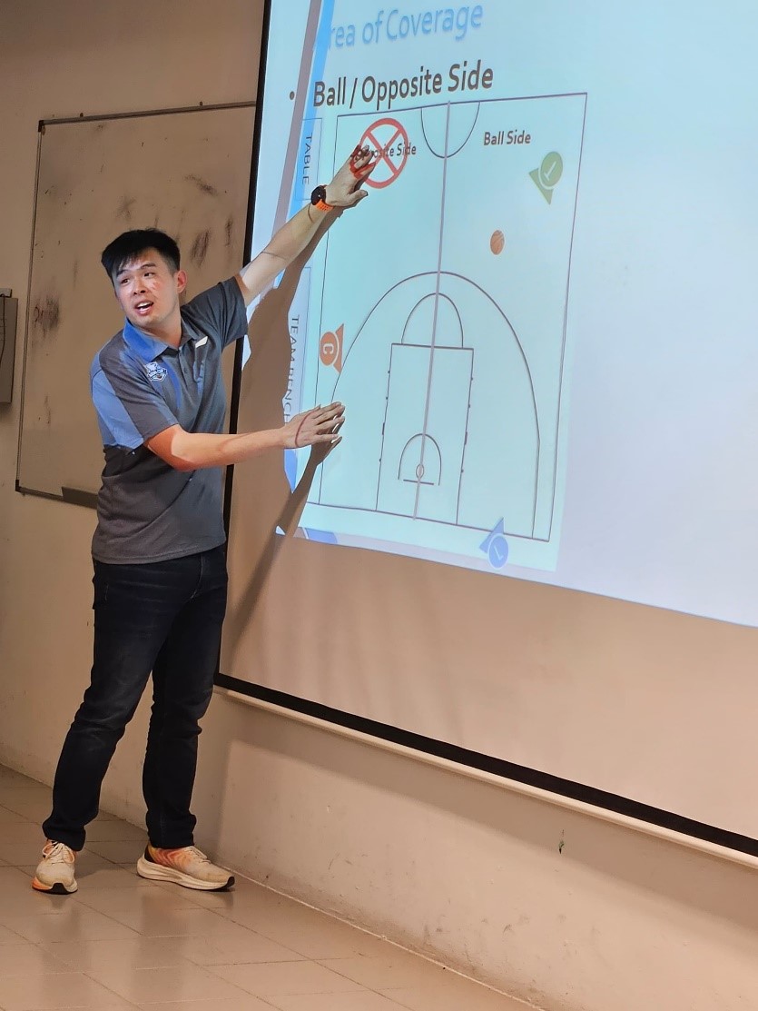 Referee Peck Meng Cong explaining the area of court coverage during the theory session