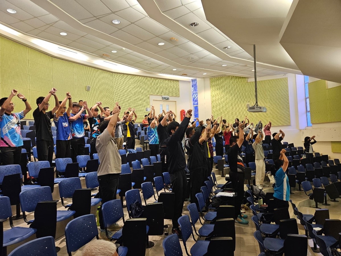 Participants practising official hand signals used by referees to communicate fouls and violations