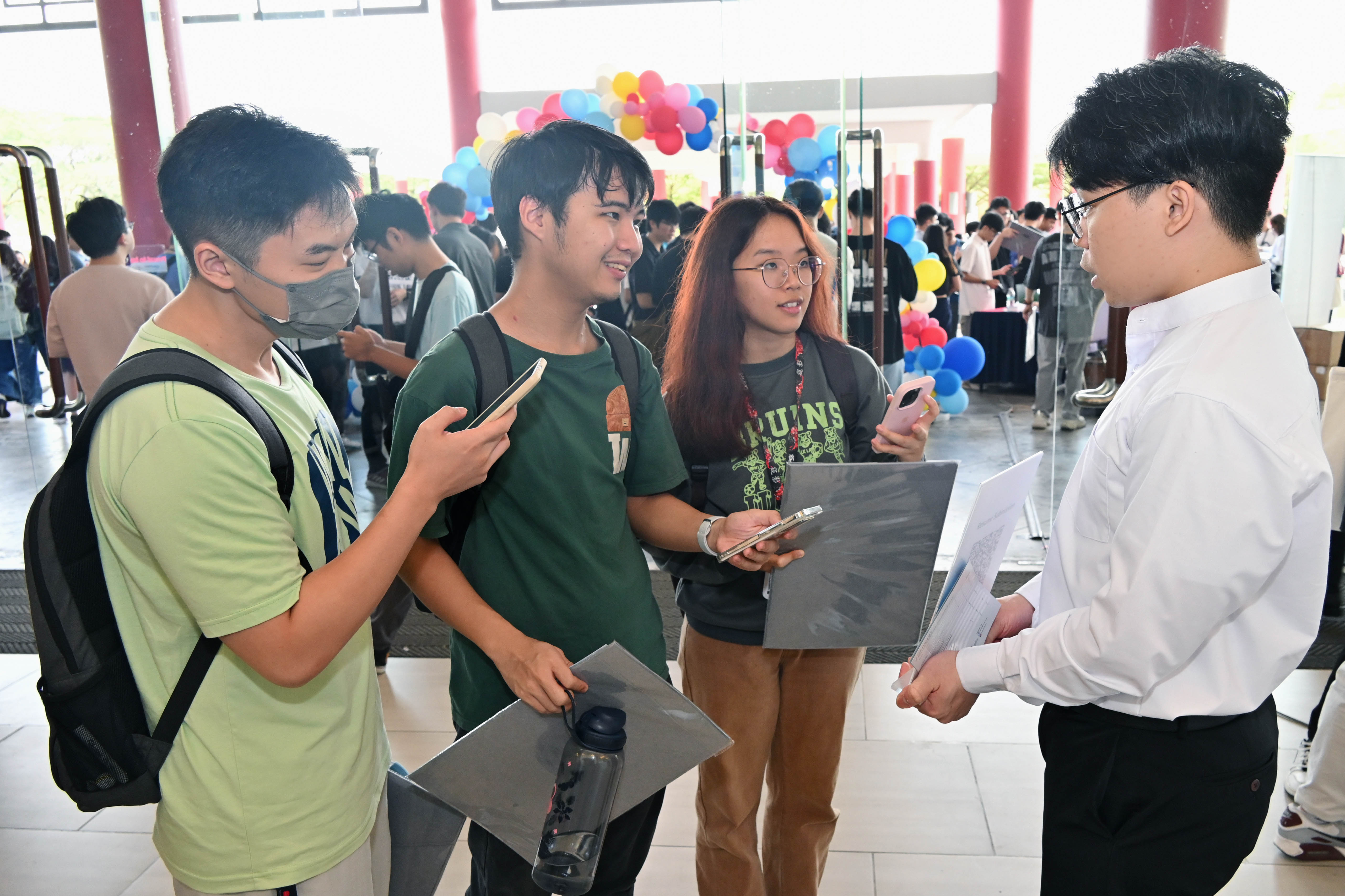 Students inquiring about the career event at the information booth