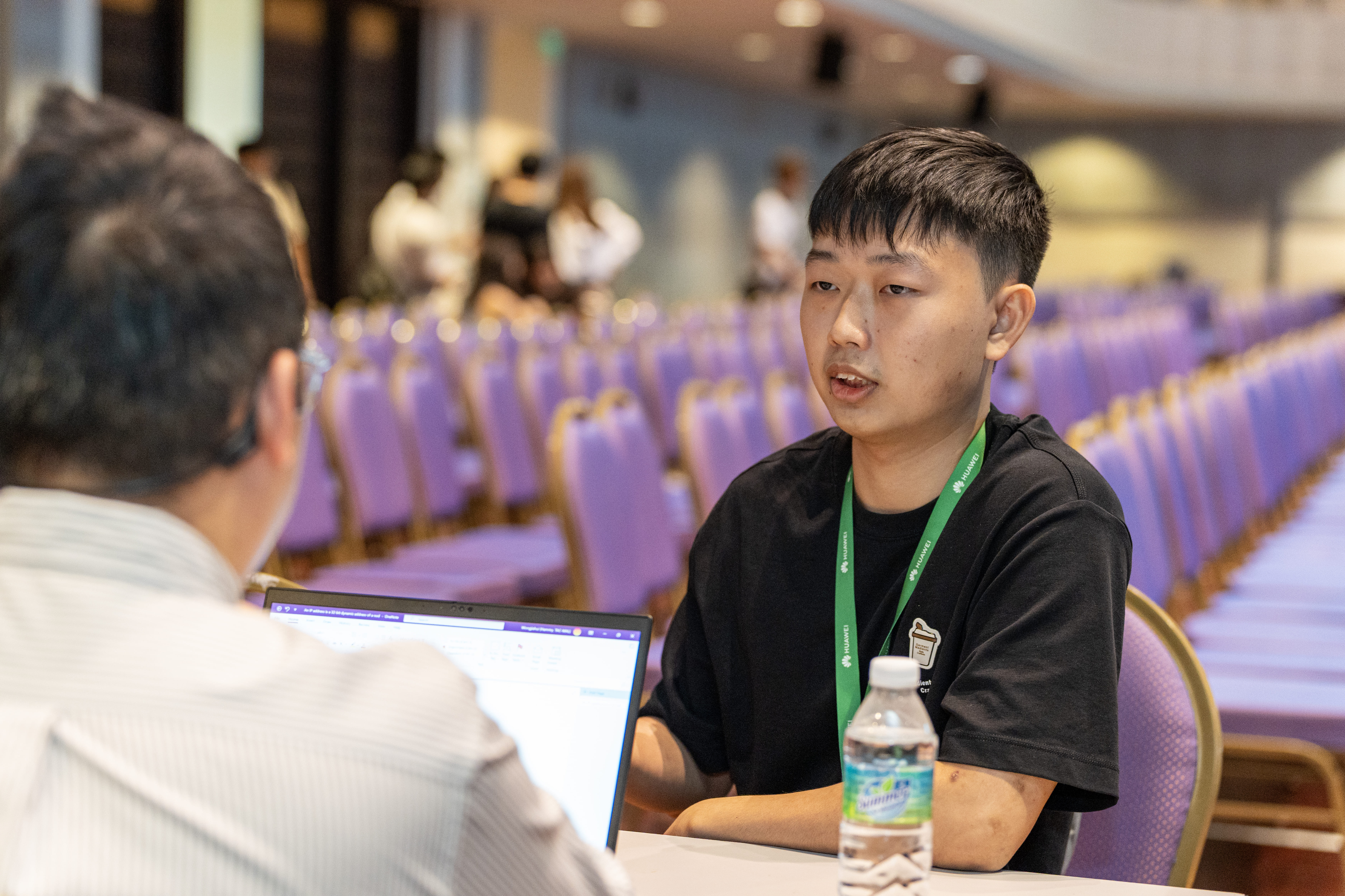Participants engaging with interviewers with focused resolve at the live interview corner