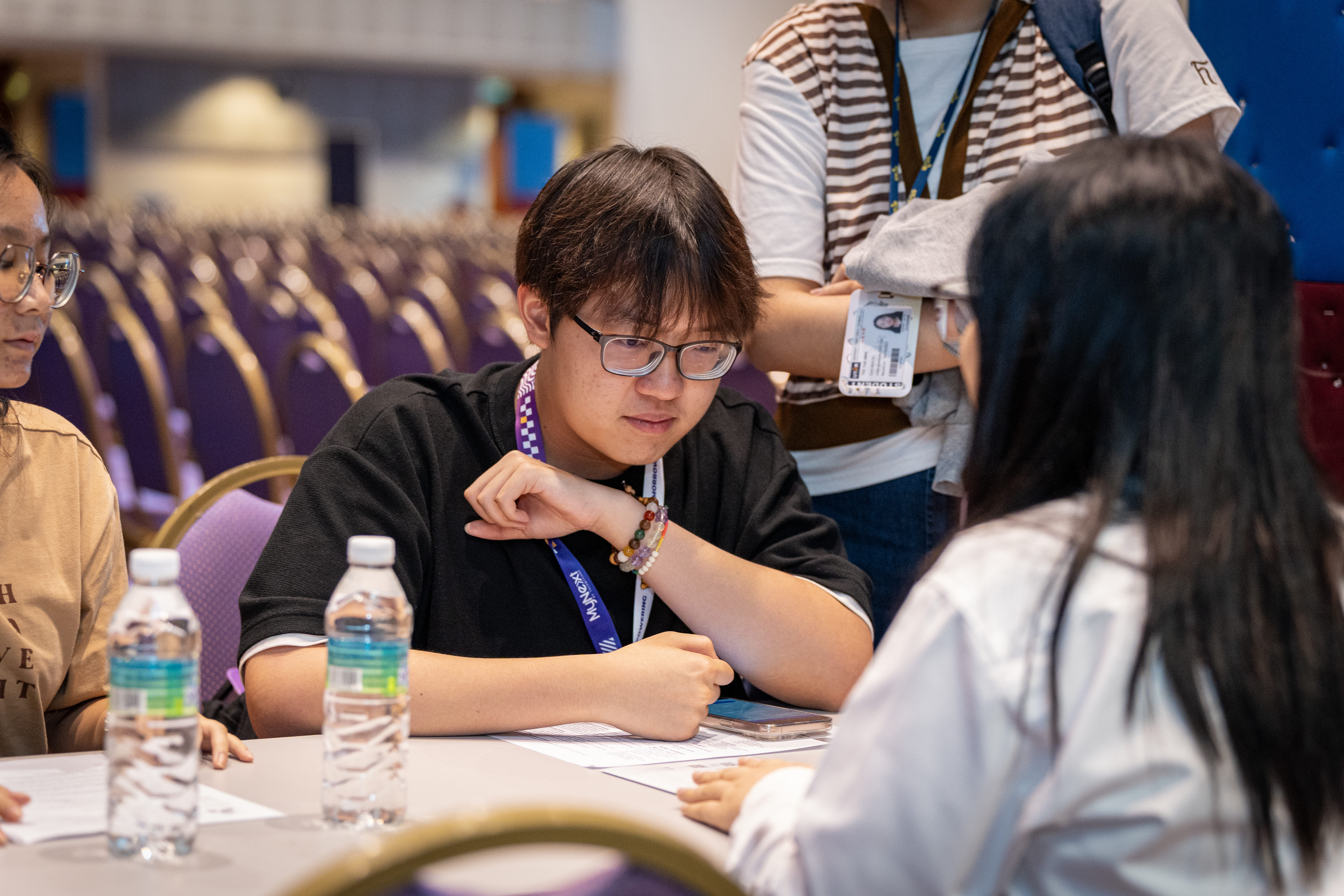 Participants engaging with interviewers with focused resolve at the live interview corner