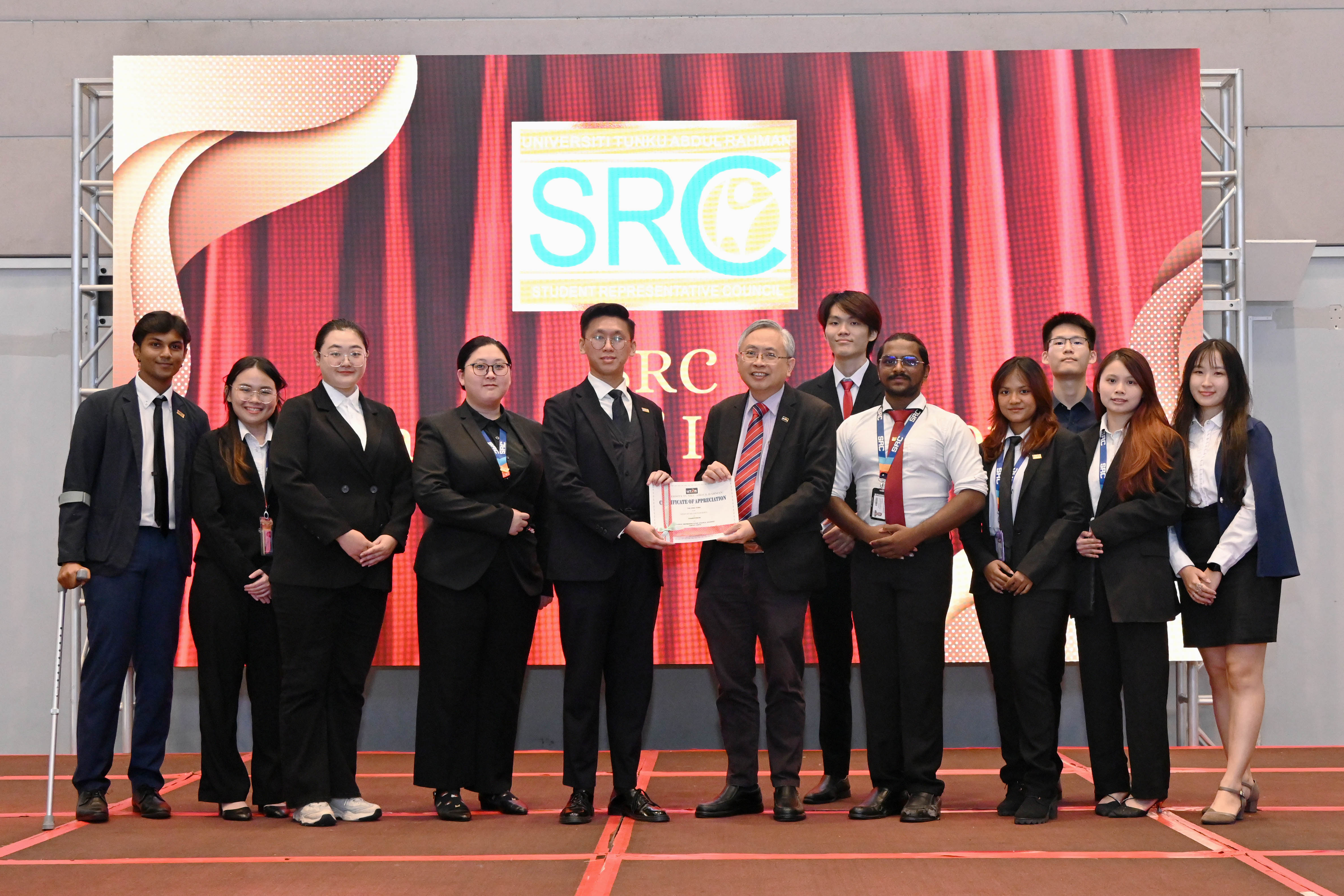SRC 2024/2025 members receiving certificates from Prof Dato' Ewe for their invaluable service to the student community