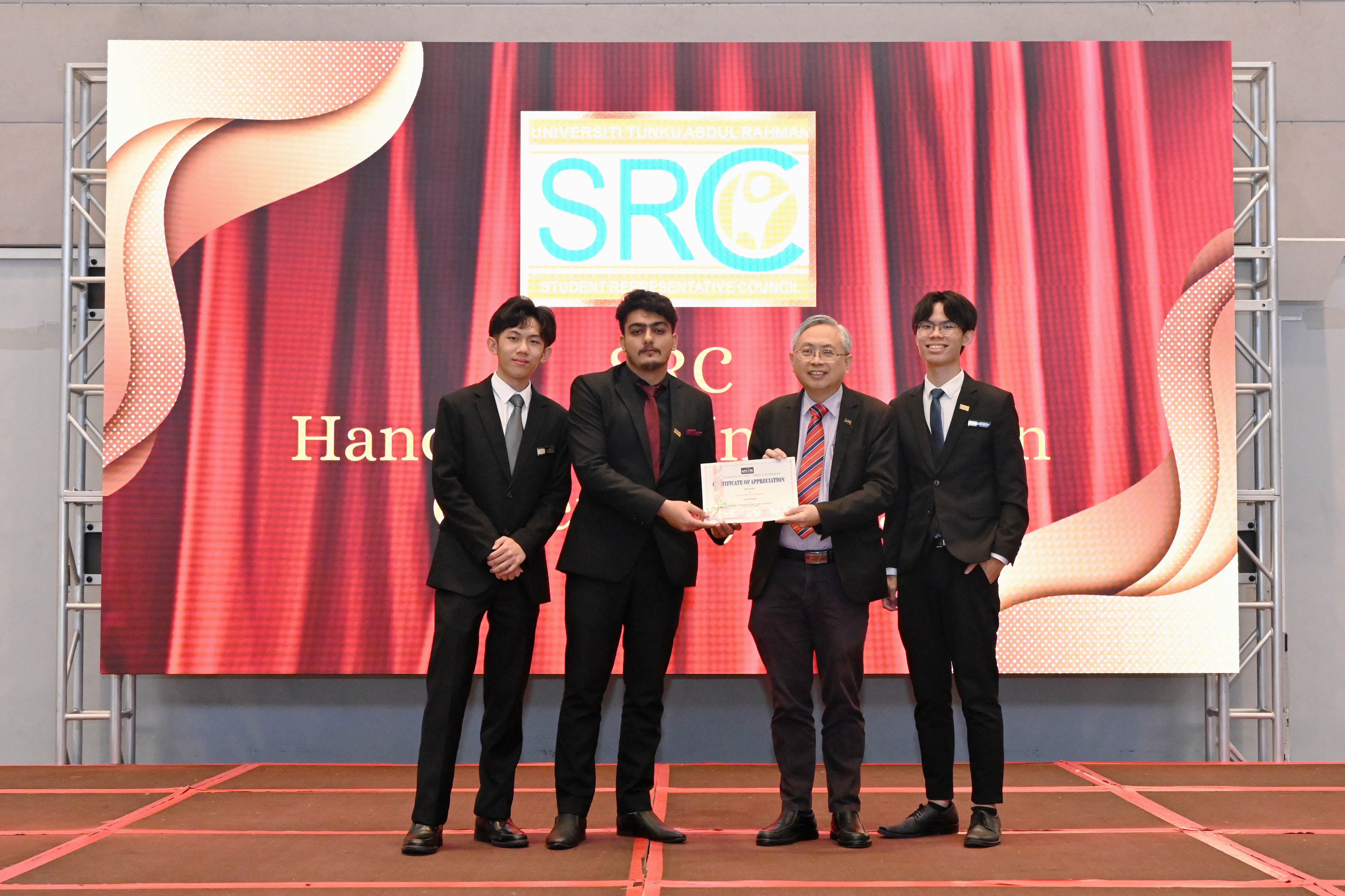 SRC 2024/2025 members receiving certificates from Prof Dato' Ewe for their invaluable service to the student community