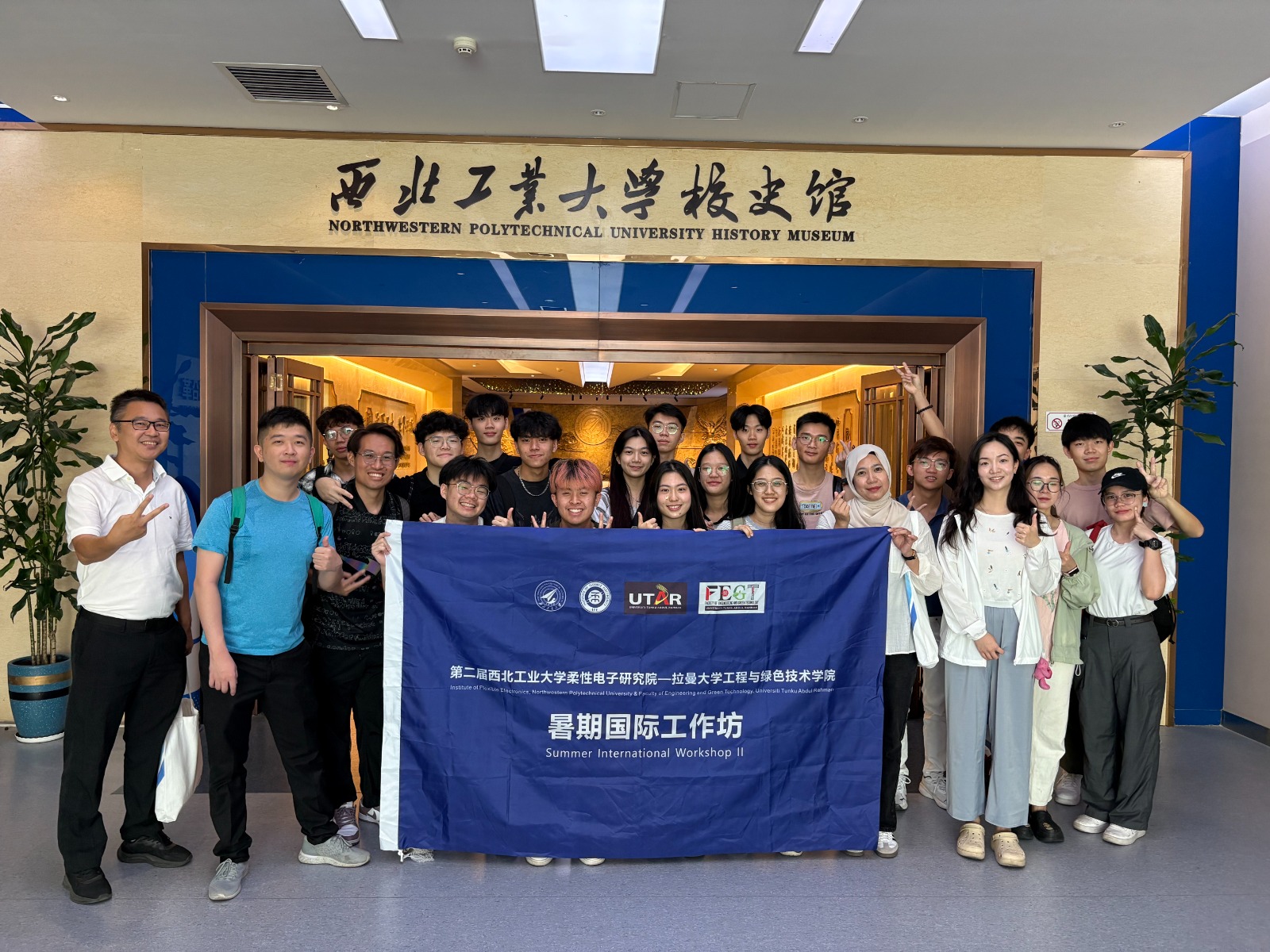 The group posing for a photograph after exploring NPU’s heritage at the history museum