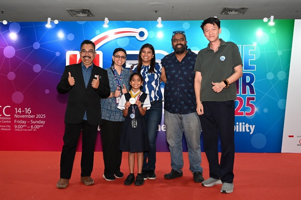 Myra (third from left) on stage with her medal