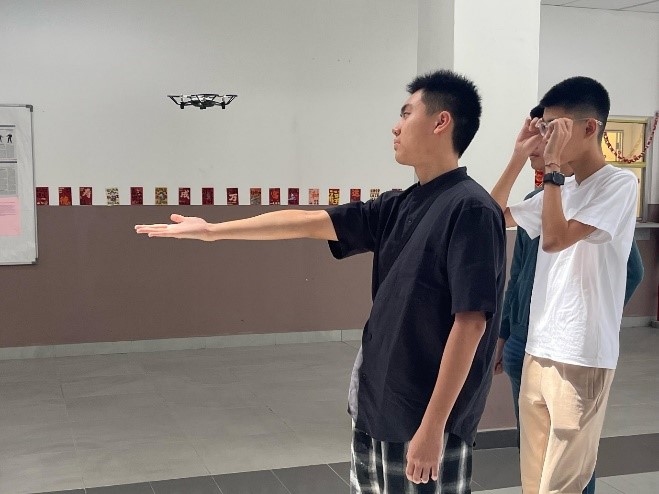 Students experiencing the thrill of flying a drone