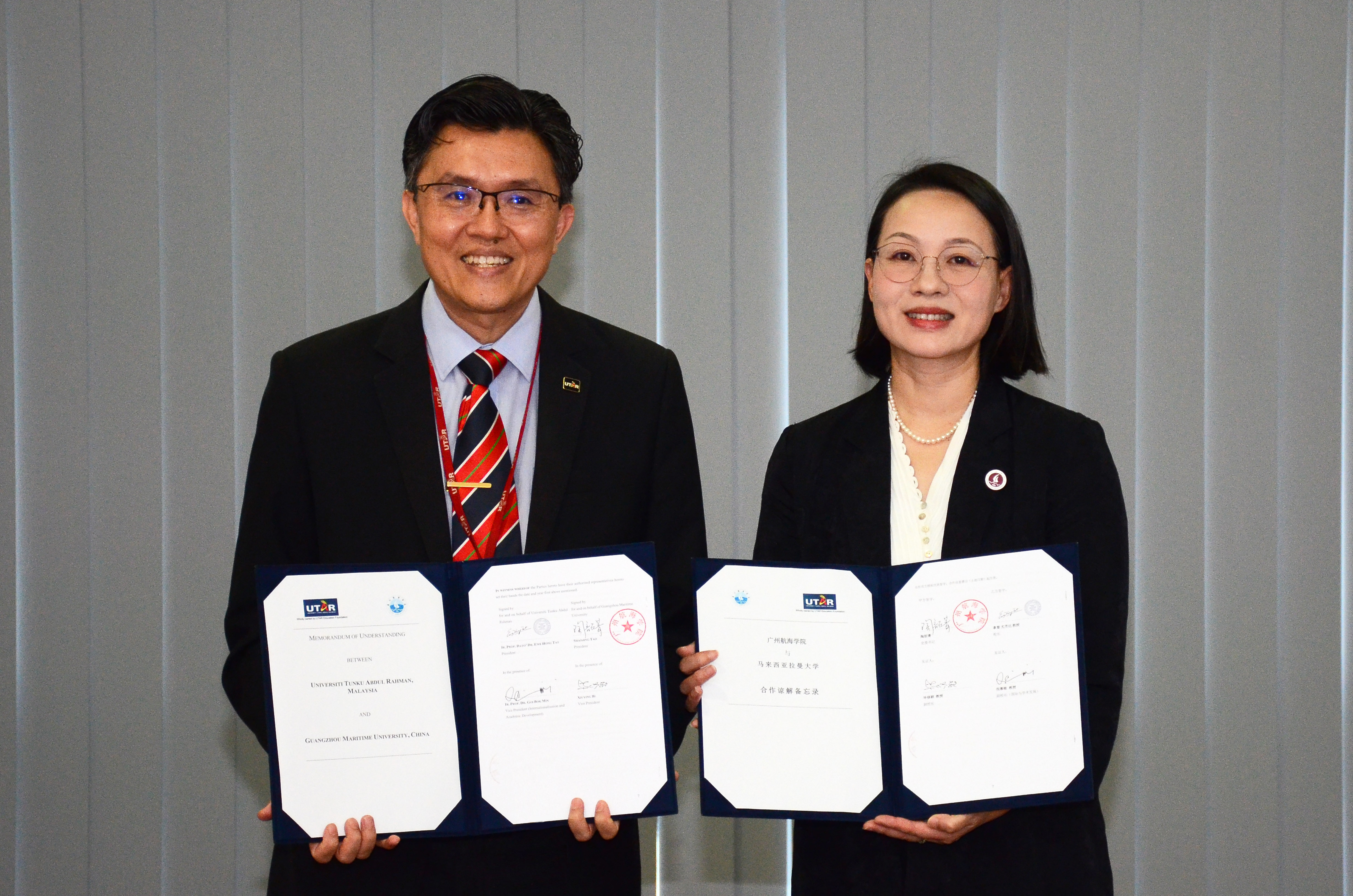 Prof Goi (left) holding the signed MoU with Prof Tao