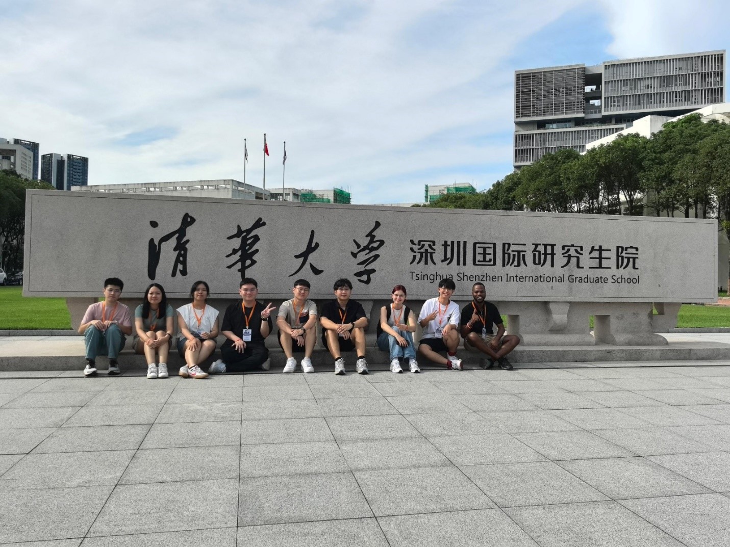 Lee, Khoo (first and second from left), Tee (fourth from left), Tan, and Mooi with international peers at the entrance of Tsinghua SIGS
