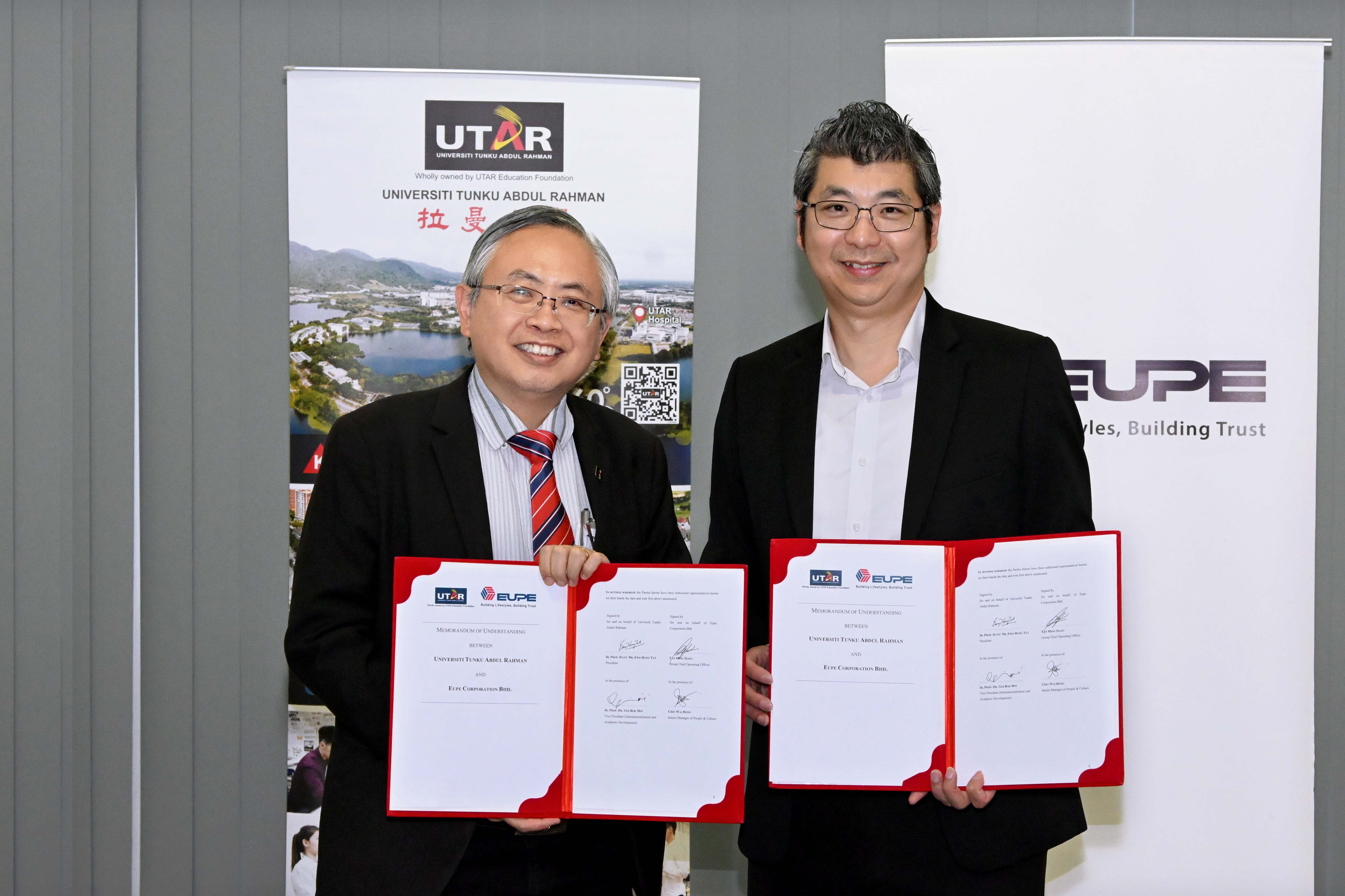 Prof Dato’ Ewe (left) and Mr Tan displaying the signed documents