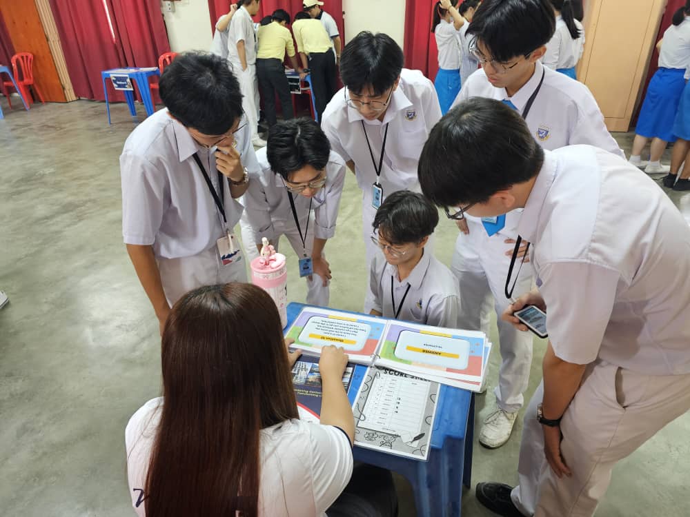 Students putting their minds together to crack challenging riddles at the Riddle Station