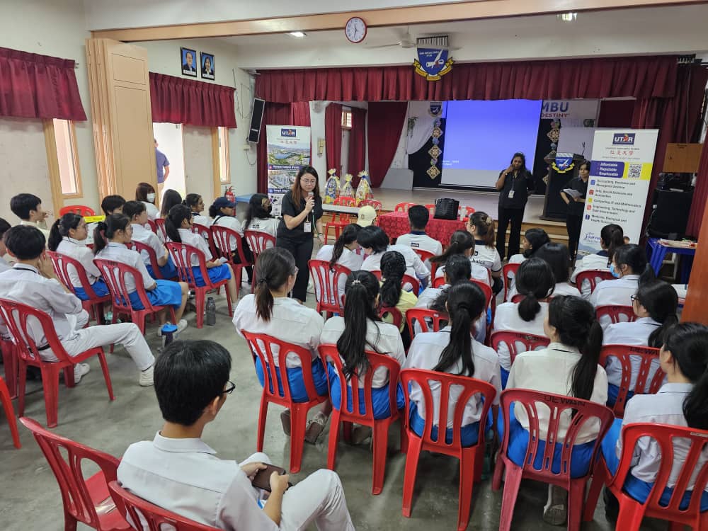 All eyes on the emcee as students await the big reveal of the mystery game challenge results