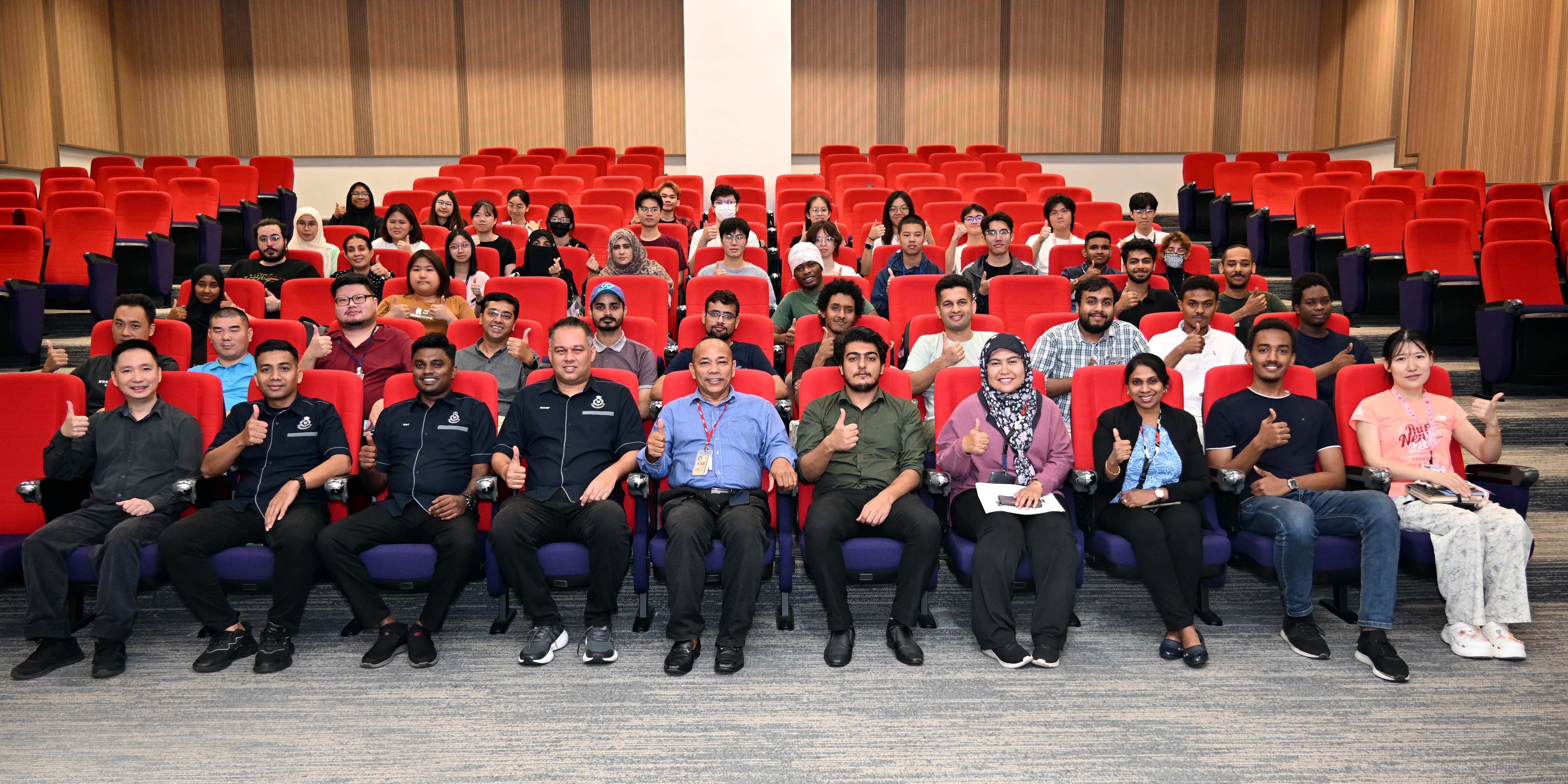 Group photo featuring UTAR staff, police officers, and international students at the end of the session