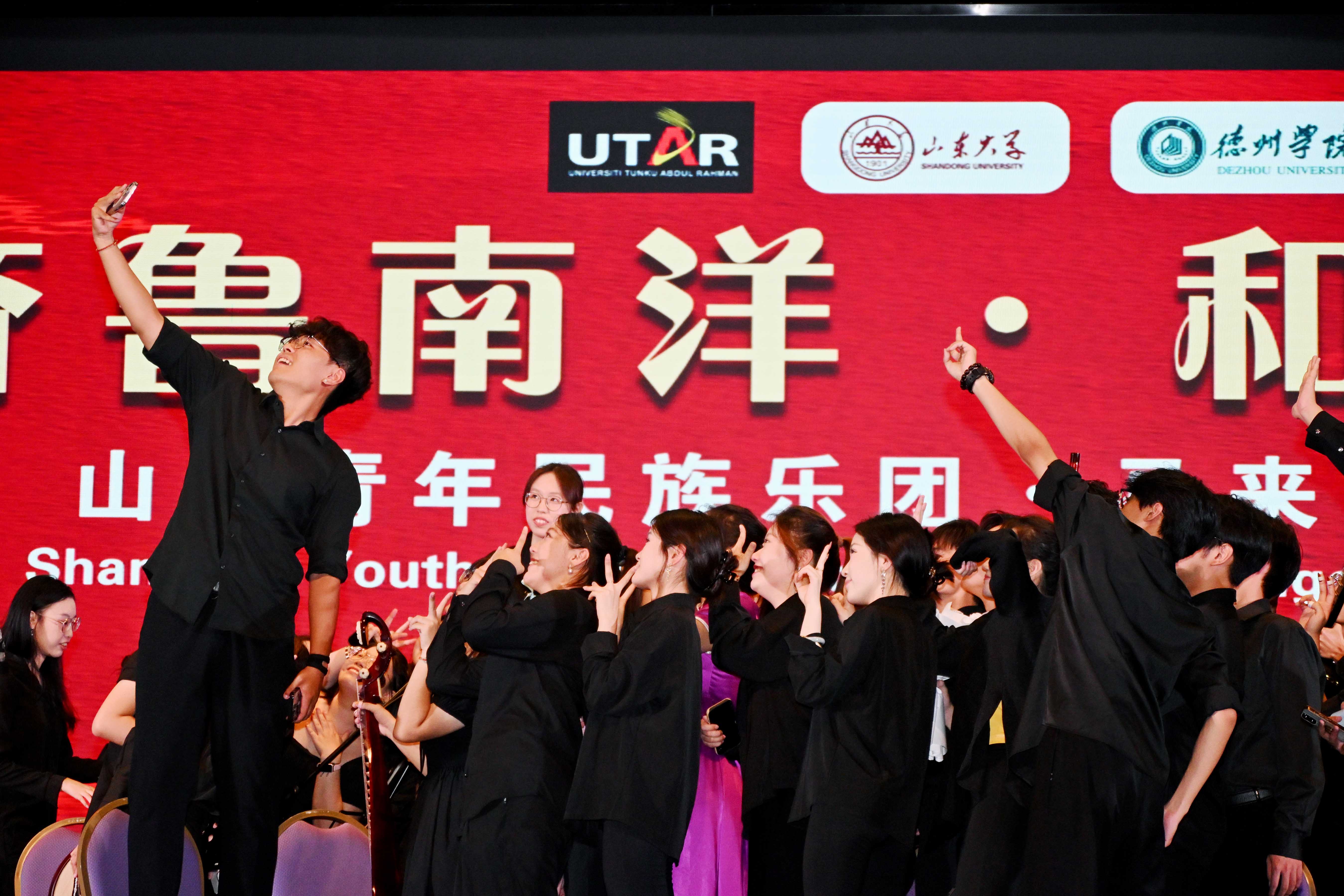 A memory to be cherished — Performers from the three universities taking photographs after the concert
