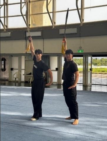 A UTAR club member practising Wushu techniques with the Wushu Team from the National Taiwan Sport University