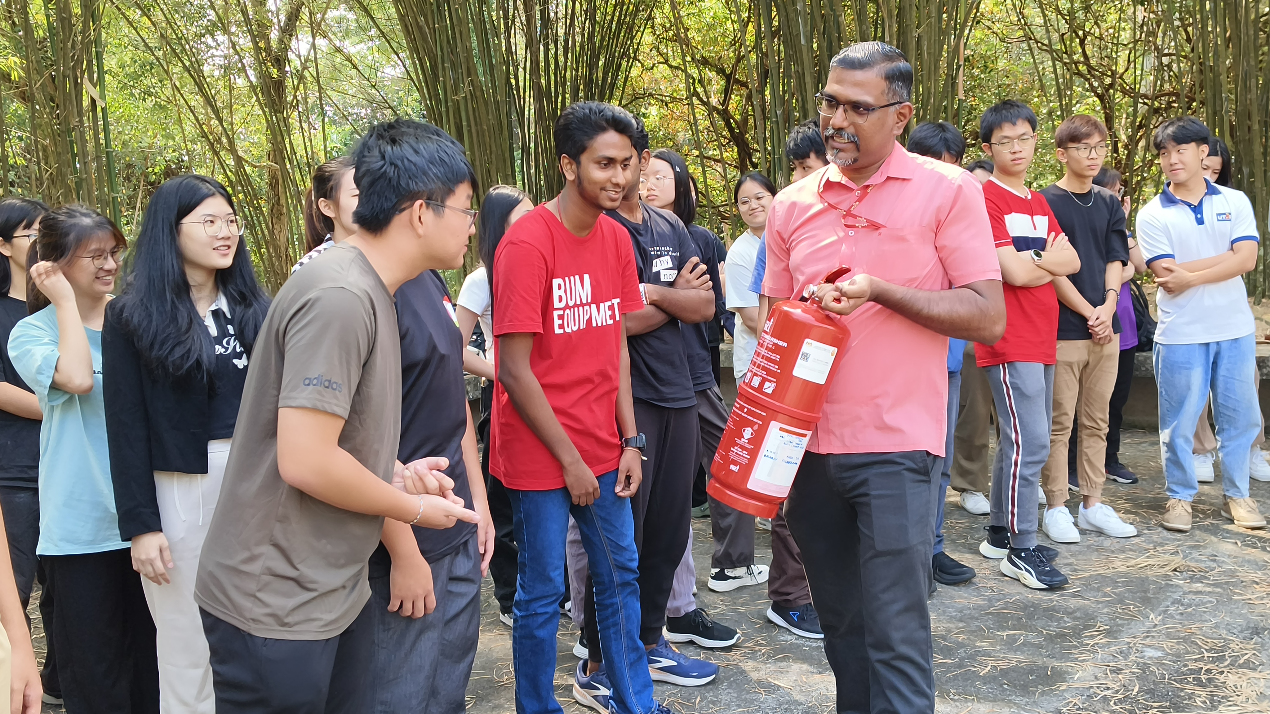 Mr Prakash explaining the procedure of using a fire extinguisher to students during the hands-on session