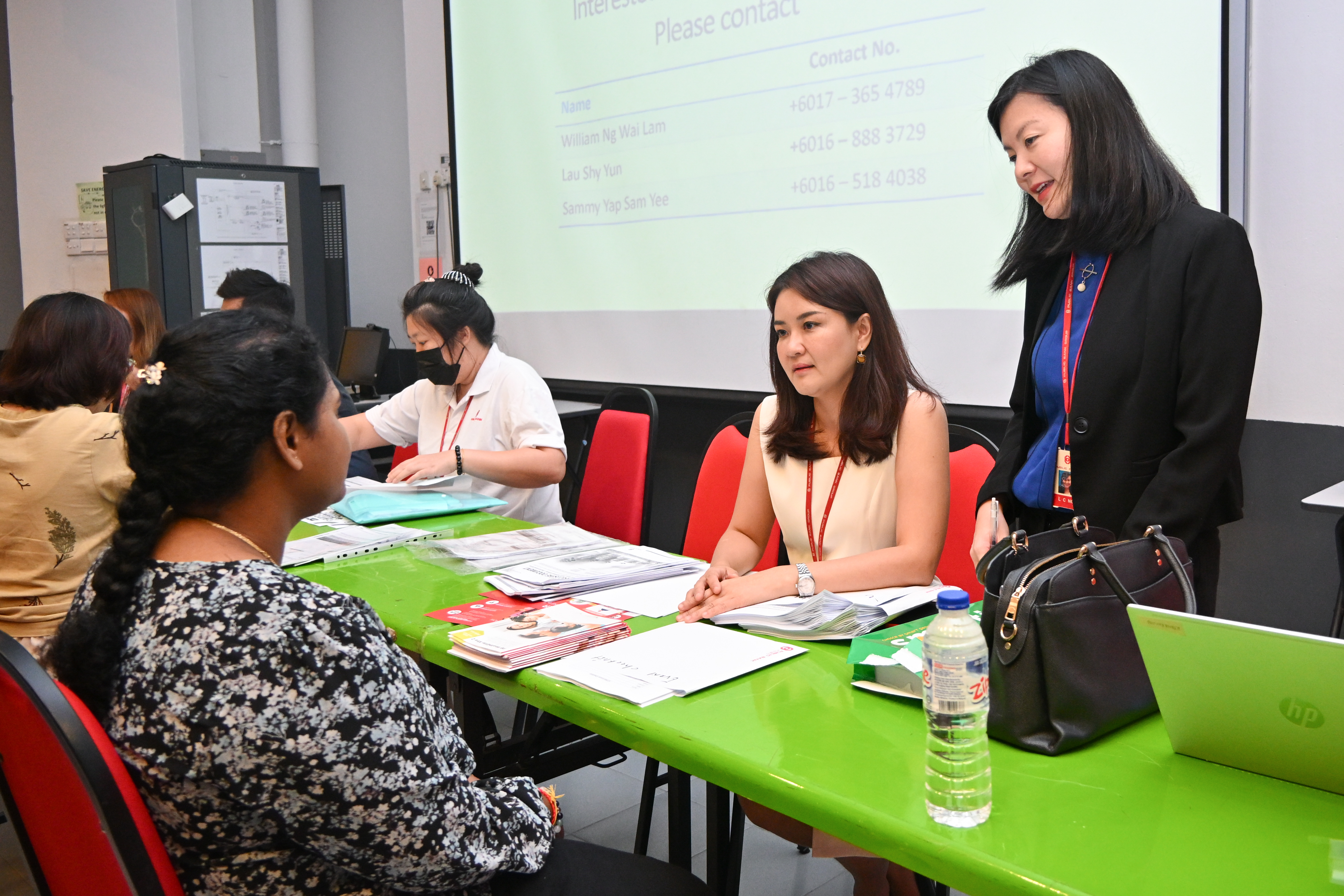 UTAR staff consulting with professionals from PBB at the mobile counters
