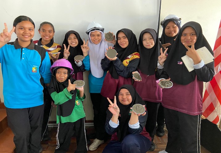 Students showing their DIY Green Coaster