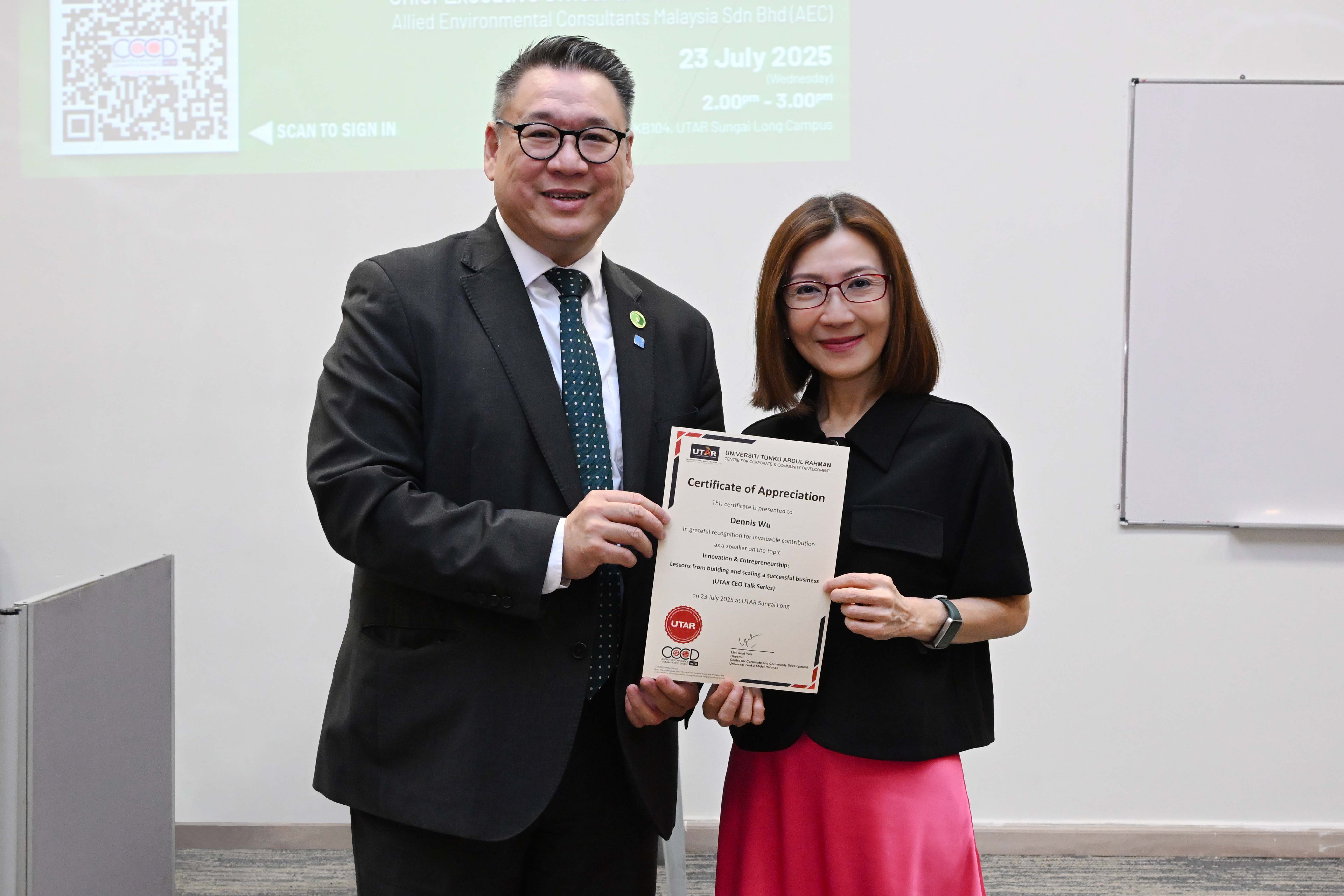CCCD Director Ms Lim Guat Yen (right) presenting a token of appreciation to Mr Wu