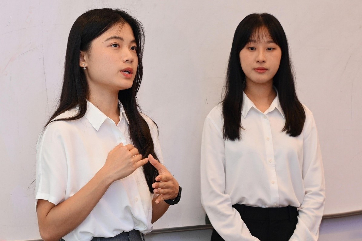 Soh (left) and Tan (right) presenting their research findings 