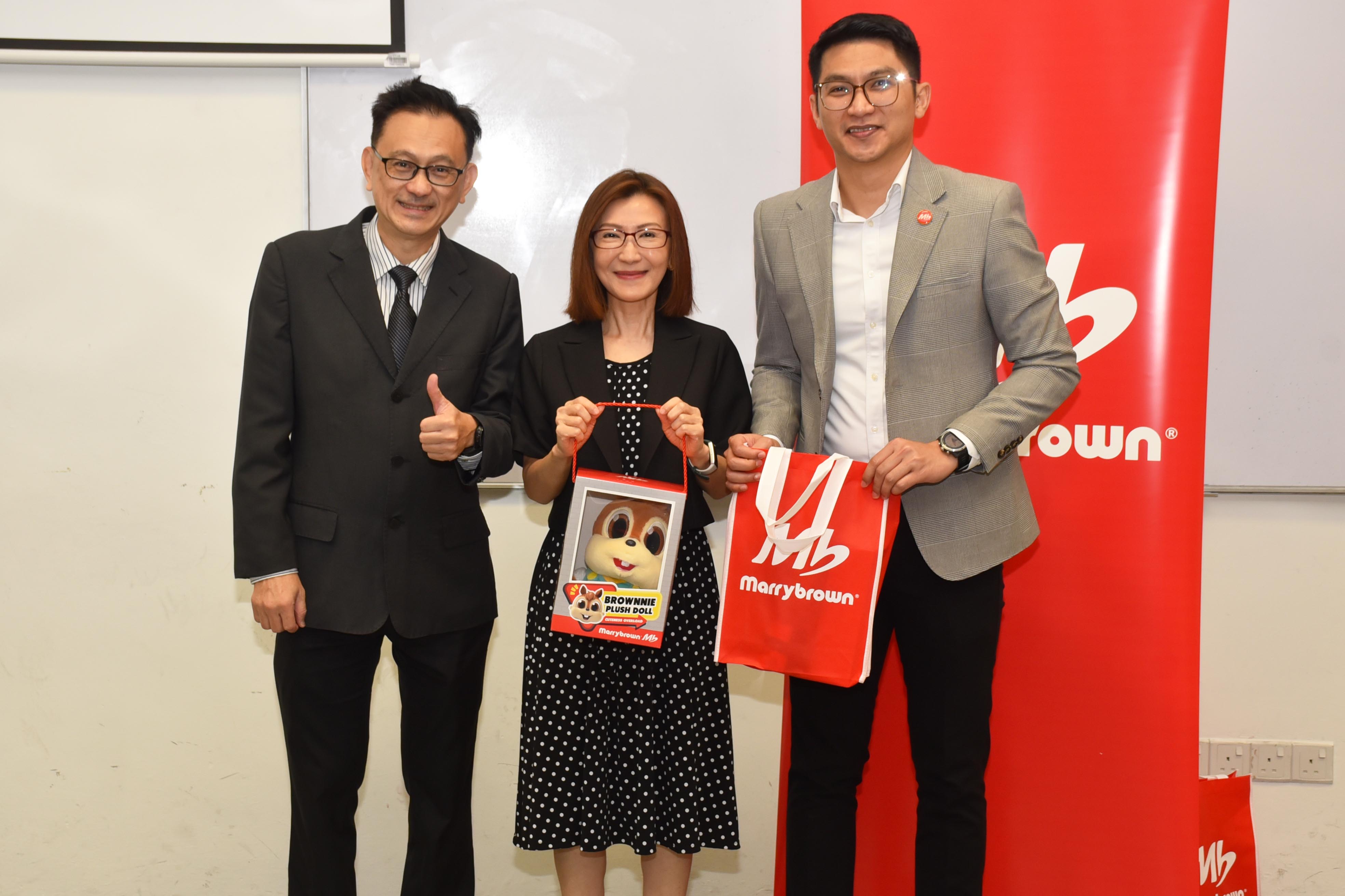 Mr Daniel Chan (far left) presenting a token of appreciation to Ms Lim