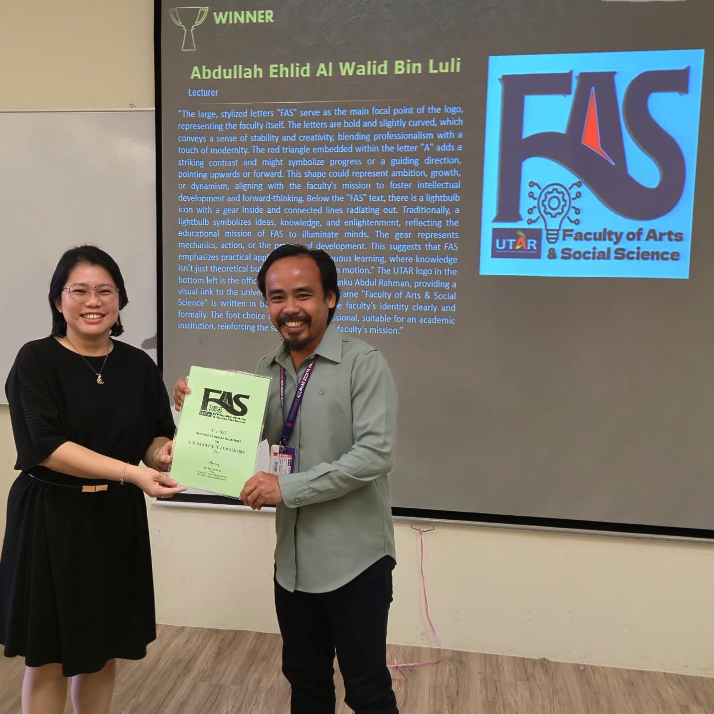 Ms Kok (left) presenting the award to Mr Abdullah Ehlid
