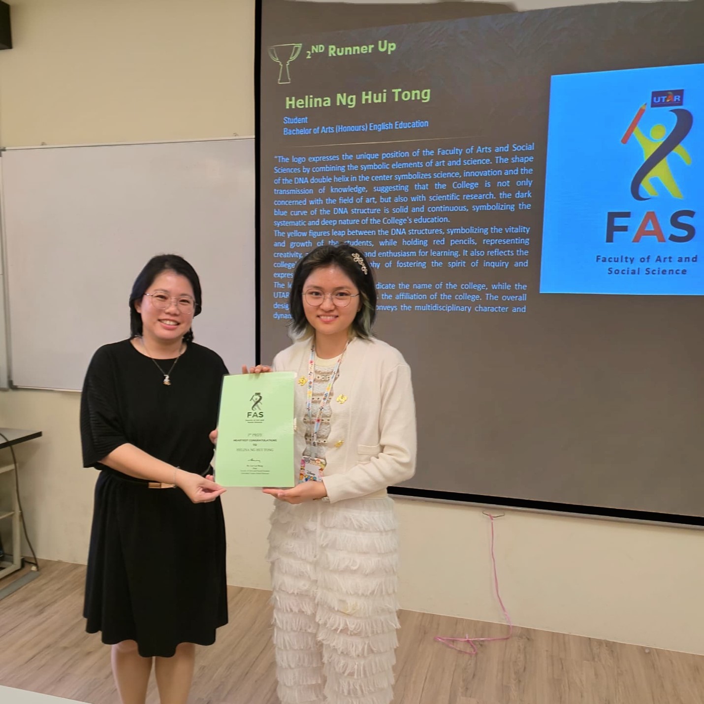 Ms Kok (left) presenting the award to Helina Ng