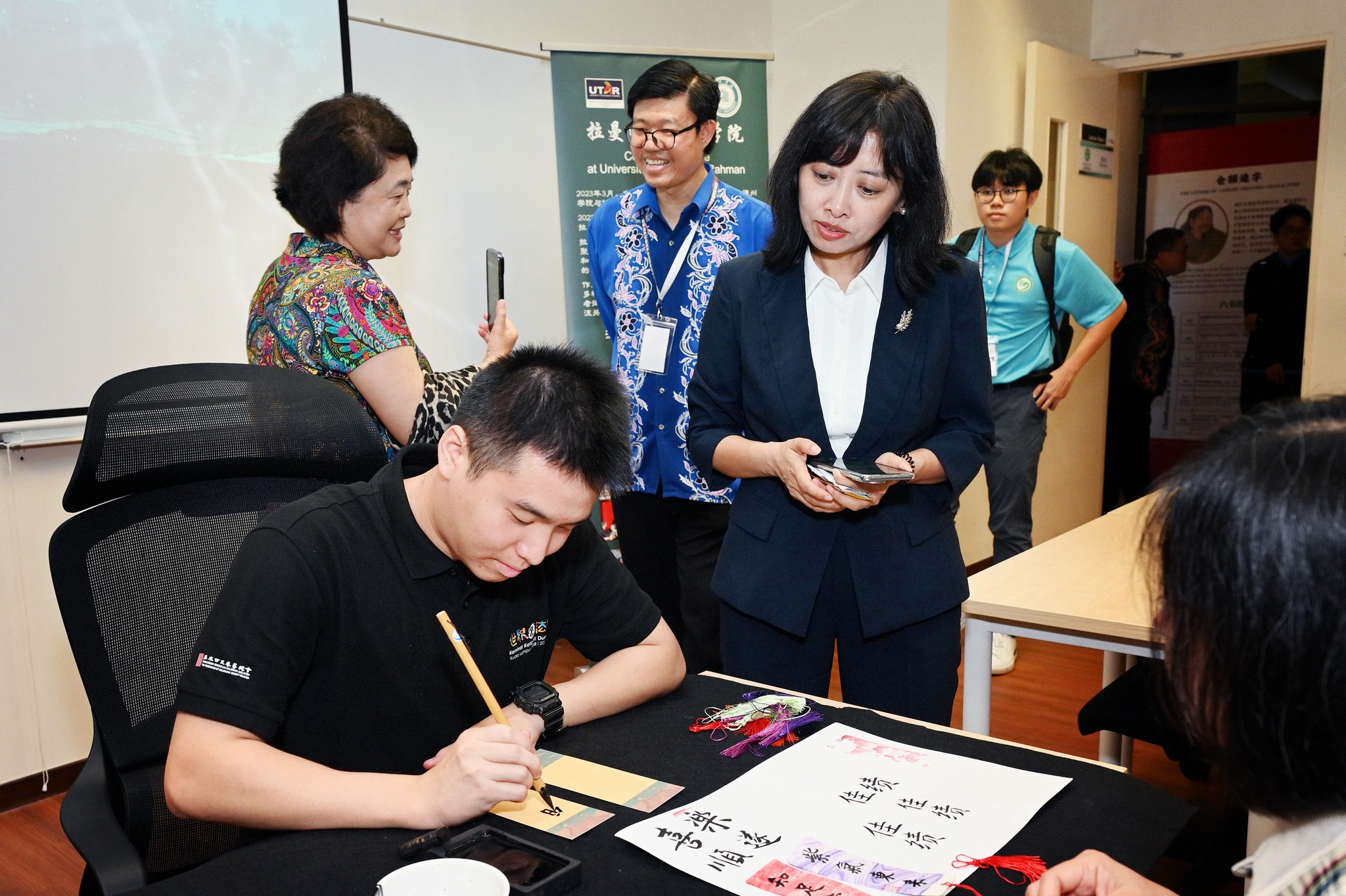 Participant writing a message on a bookmark