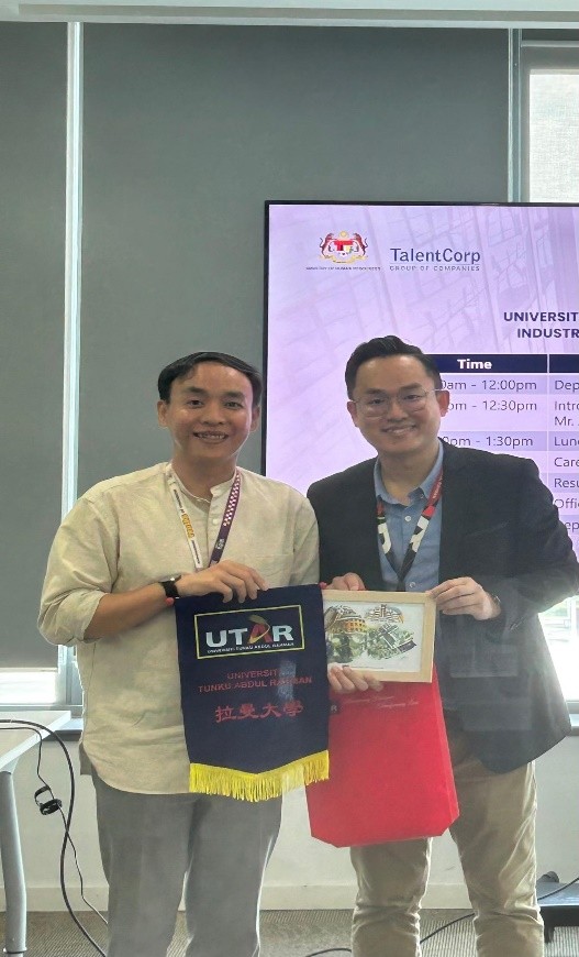 Mr Low presenting a token of appreciation to Mr Ardi (right)