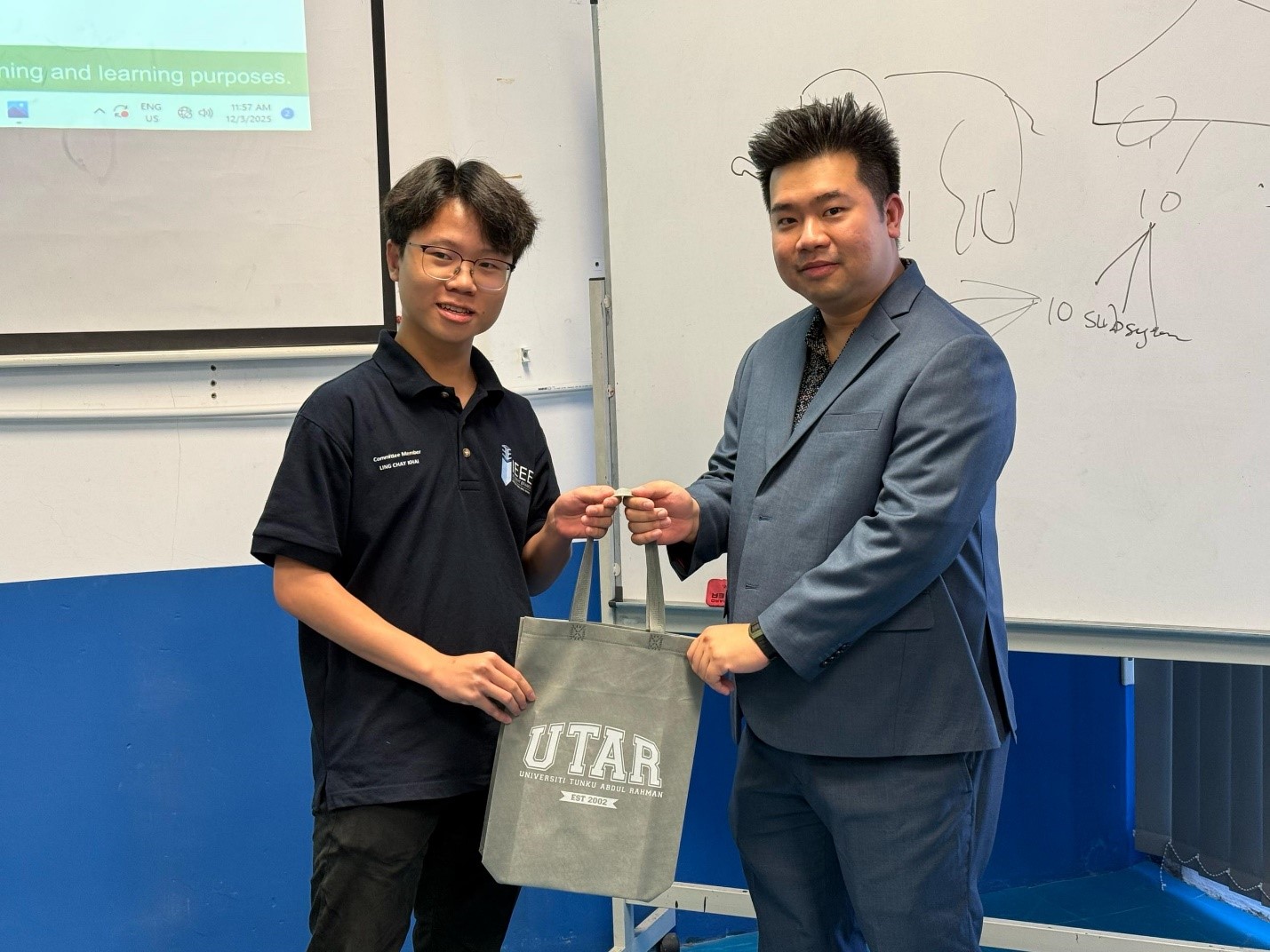 Ling (left) presenting a token of appreciation to Mr Ng