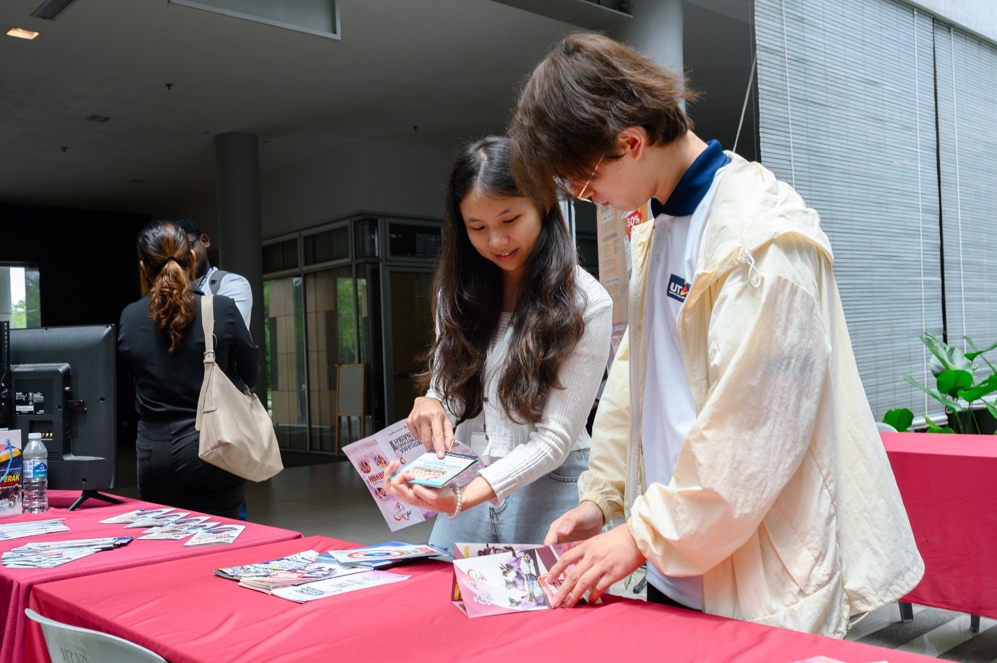 Students perusing crime prevention pamphlets to better understand the tactics used in job scams