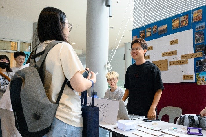 Participants thronging the booths outside of the Multipurpose Hall, indulging in a vibrant and diverse experience