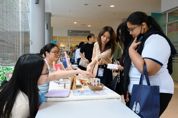 Participants thronging the booths outside of the Multipurpose Hall, indulging in a vibrant and diverse experience
