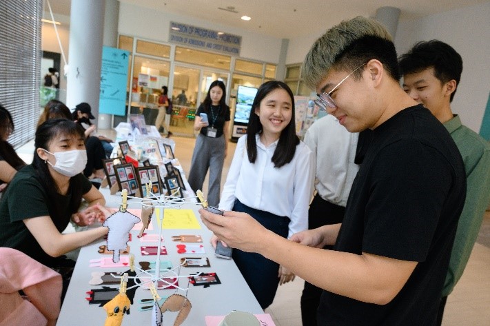 Participants thronging the booths outside of the Multipurpose Hall, indulging in a vibrant and diverse experience