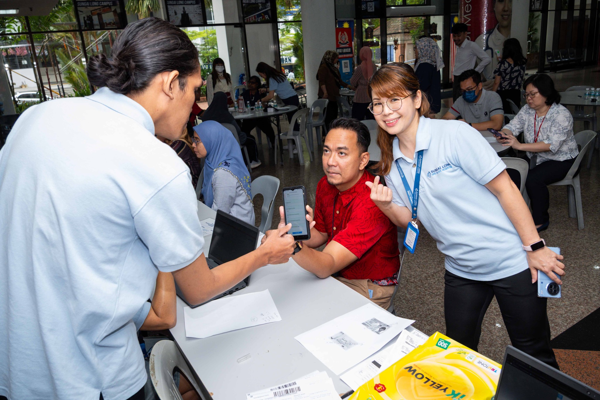 UTAR staff undergoing health screening at the South Lobby of UTAR Sungai Long Campus