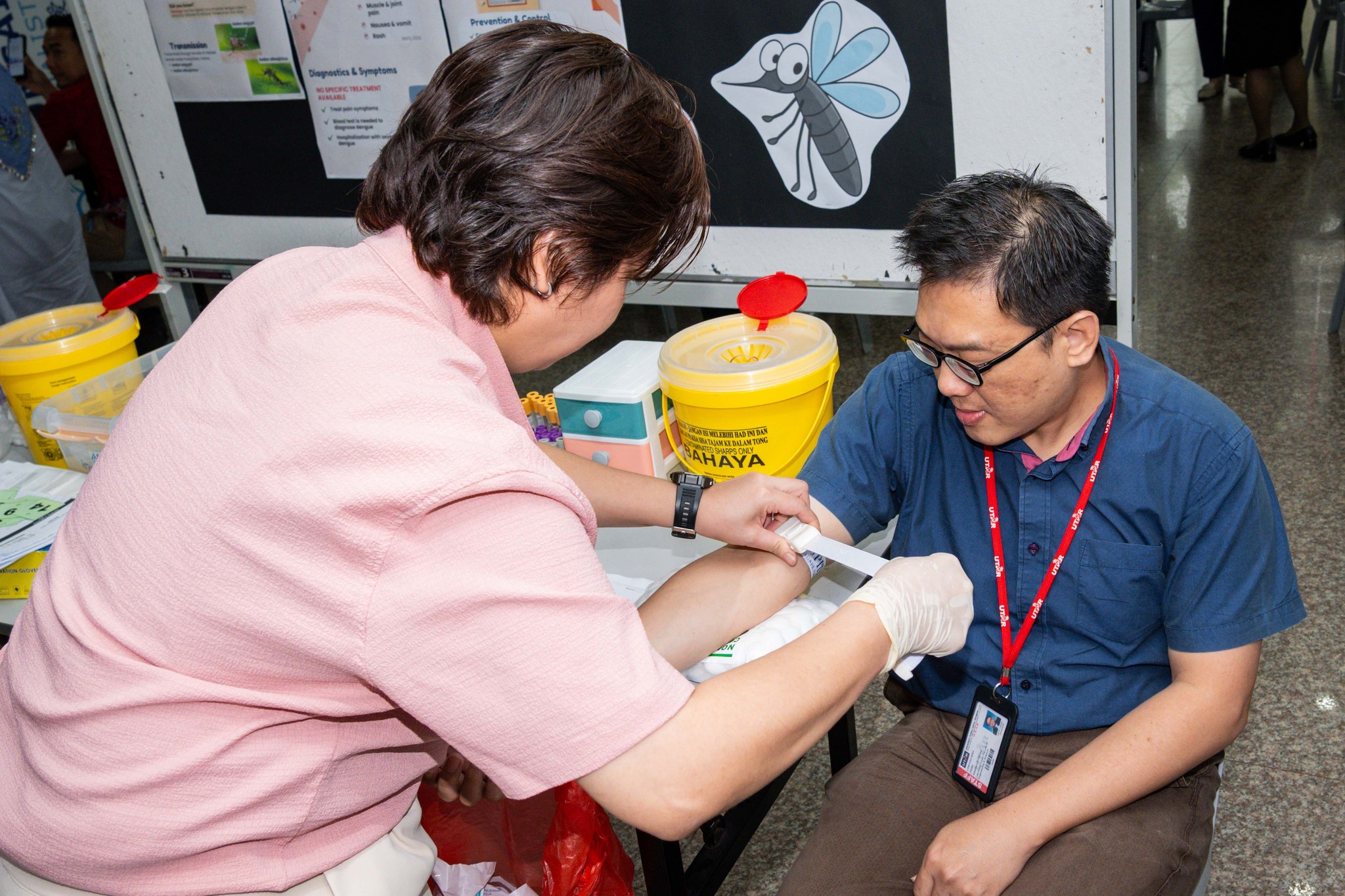 UTAR staff undergoing health screening at the South Lobby of UTAR Sungai Long Campus