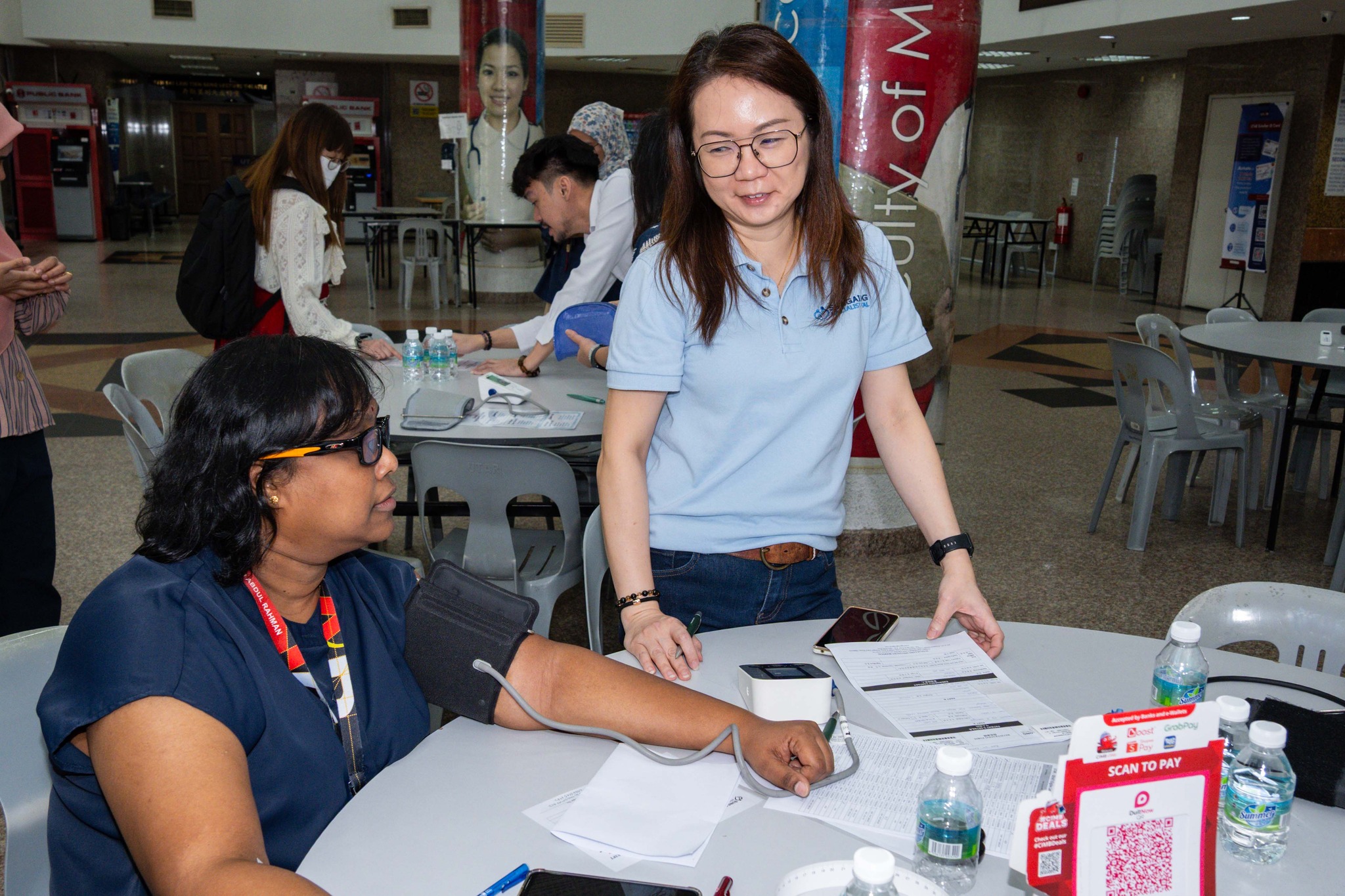 UTAR staff undergoing health screening at the South Lobby of UTAR Sungai Long Campus